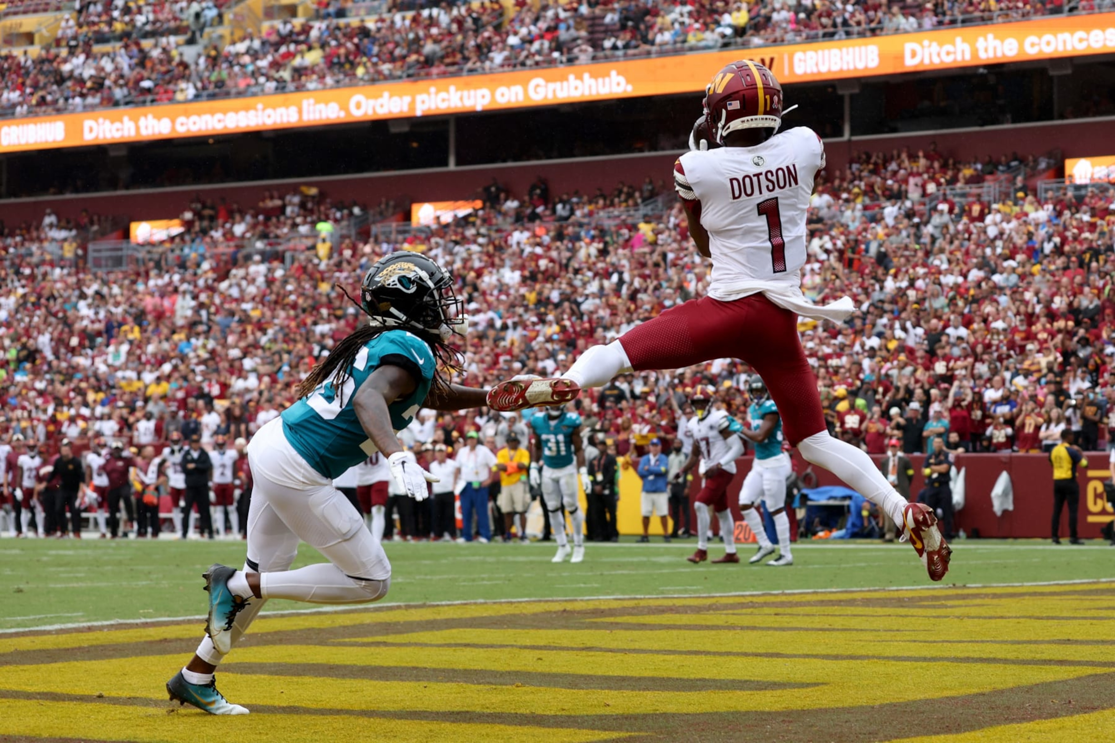 LANDOVER, MARYLAND - SEPTEMBER 11: Jahan Dotson #1 of the Washington Commanders catches a touchdown pass against Shaquill Griffin #26 of the Jacksonville Jaguars during the second quarter at FedExField on September 11, 2022 in Landover, Maryland. (Photo by Rob Carr/Getty Images)