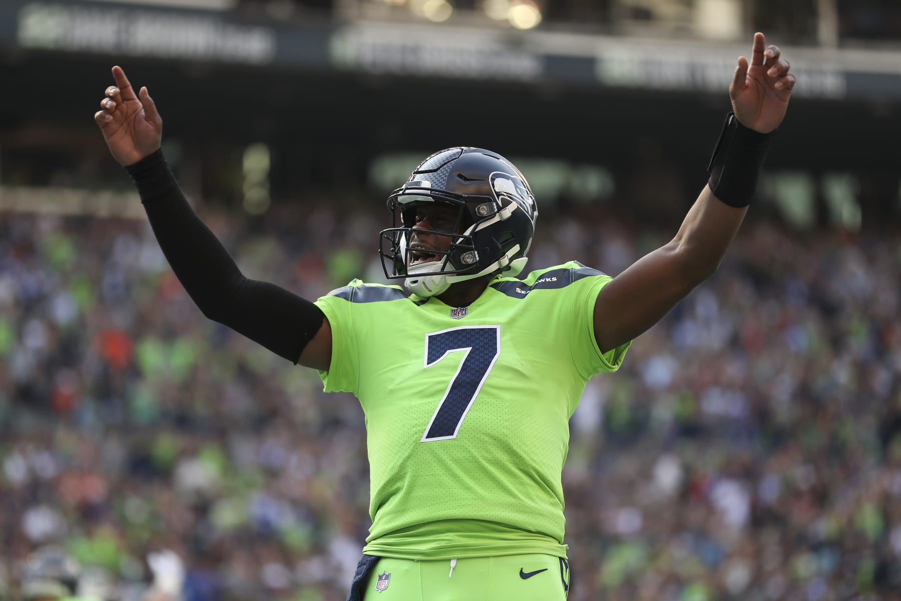SEATTLE, WASHINGTON - SEPTEMBER 12: Geno Smith #7 of the Seattle Seahawks celebrates during the first quarter against the Denver Broncos at Lumen Field on September 12, 2022 in Seattle, Washington. (Photo by Steph Chambers/Getty Images)
