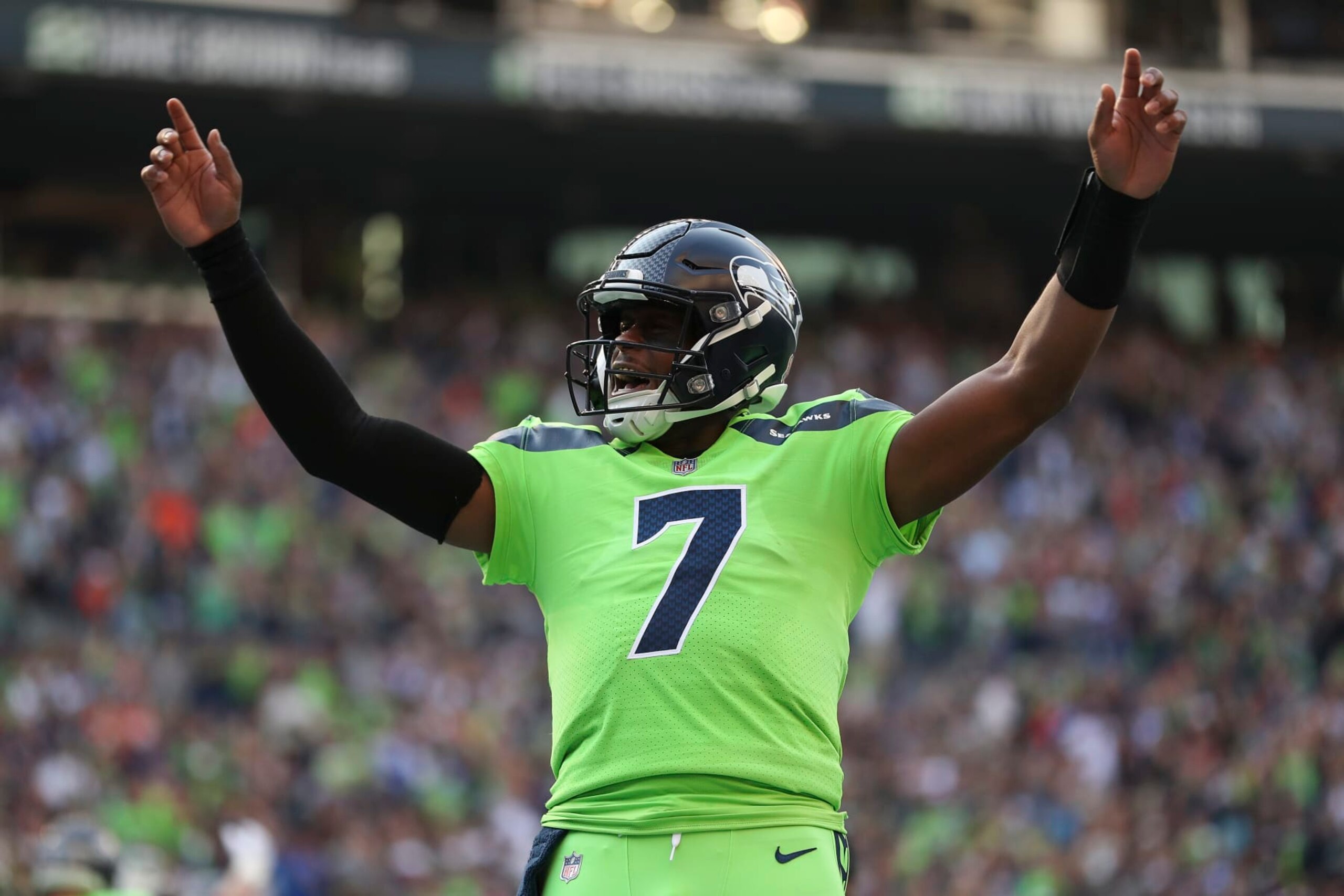 SEATTLE, WASHINGTON - SEPTEMBER 12: Geno Smith #7 of the Seattle Seahawks celebrates during the first quarter against the Denver Broncos at Lumen Field on September 12, 2022 in Seattle, Washington. (Photo by Steph Chambers/Getty Images)