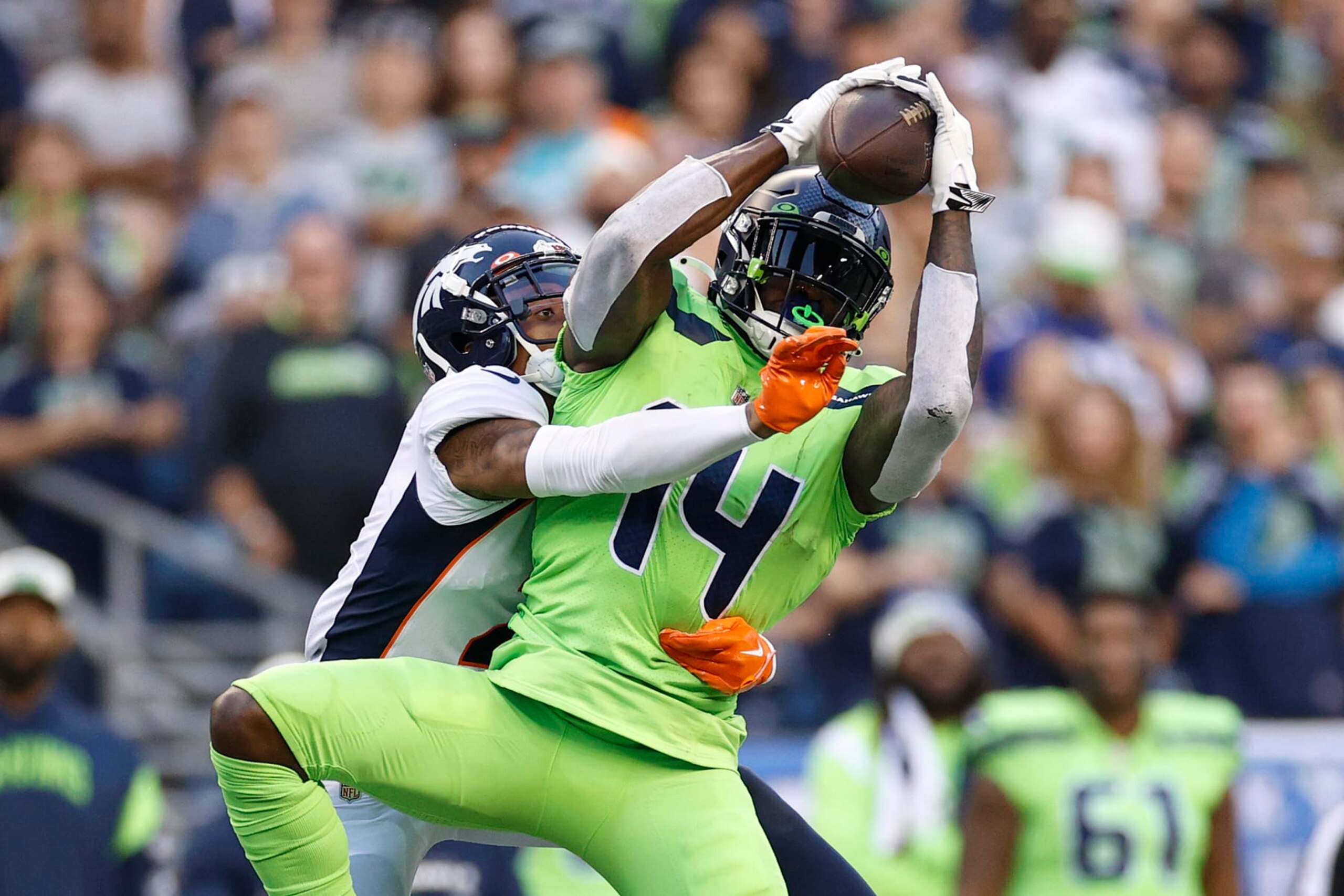 SEATTLE, WASHINGTON - SEPTEMBER 12: DK Metcalf #14 of the Seattle Seahawks makes a reception over Pat Surtain II #2 of the Denver Broncos during the third quarter at Lumen Field on September 12, 2022 in Seattle, Washington. (Photo by Steph Chambers/Getty Images)