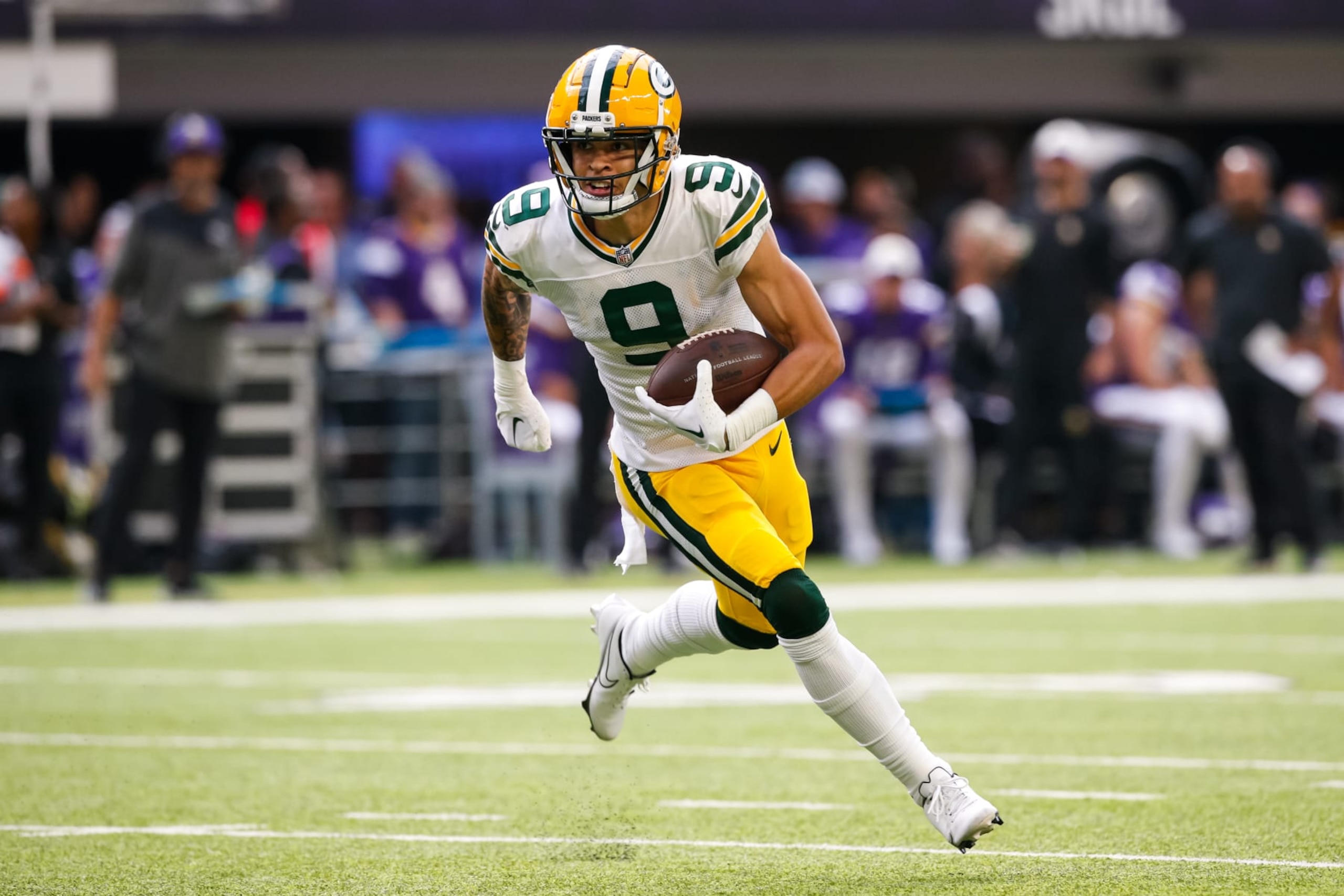 MINNEAPOLIS, MN - SEPTEMBER 11: Christian Watson #9 of the Green Bay Packers runs with the ball against the Minnesota Vikings in the second quarter of the game at U.S. Bank Stadium on September 11, 2022 in Minneapolis, Minnesota. The Vikings defeated the Packers 23-7. (Photo by David Berding/Getty Images)
