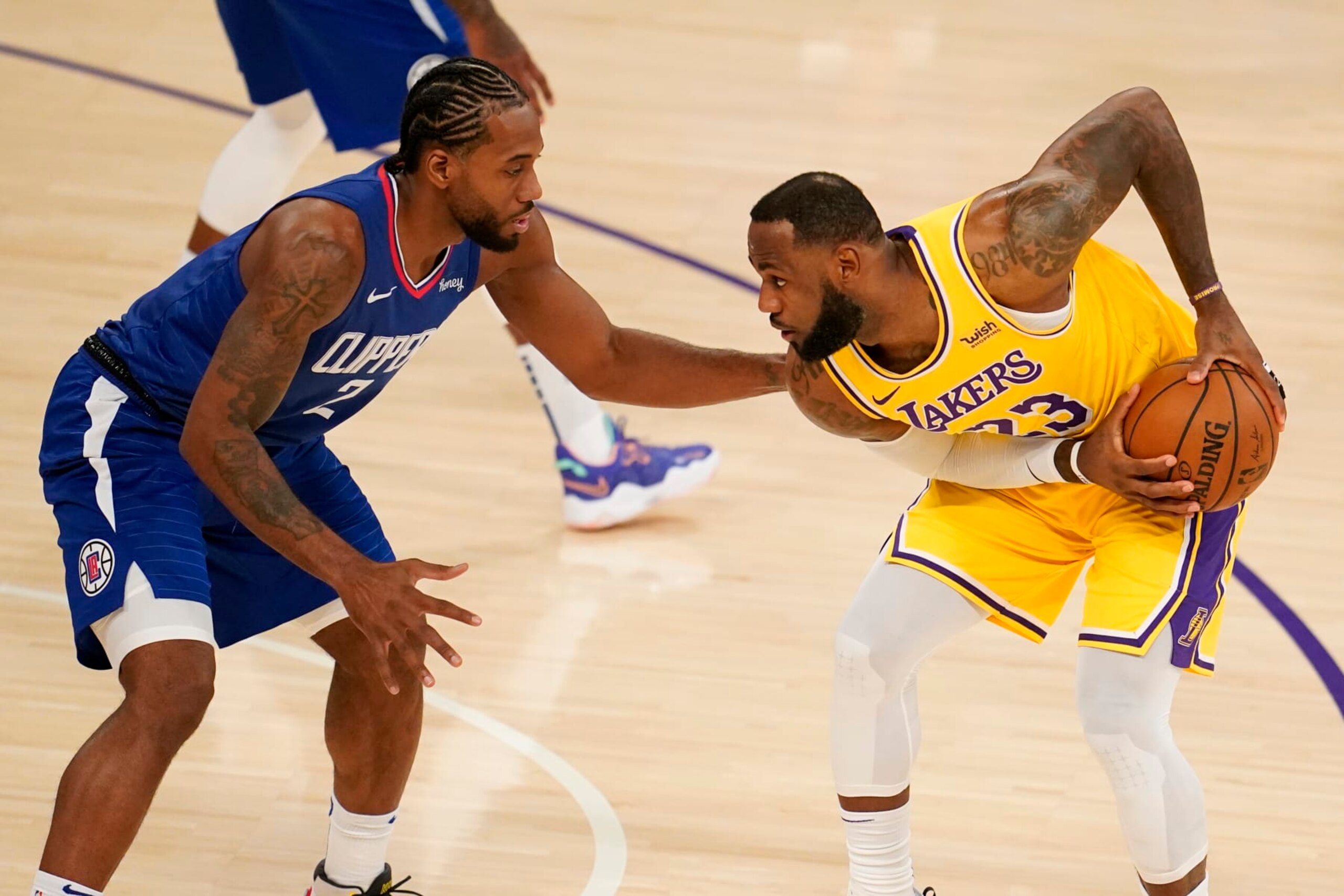 Los Angeles Lakers forward LeBron James, right, is defended by Los Angeles Clippers forward Kawhi Leonard during the first half of an NBA basketball game Tuesday, Dec. 22, 2020, in Los Angeles. (AP Photo/Marcio Jose Sanchez)