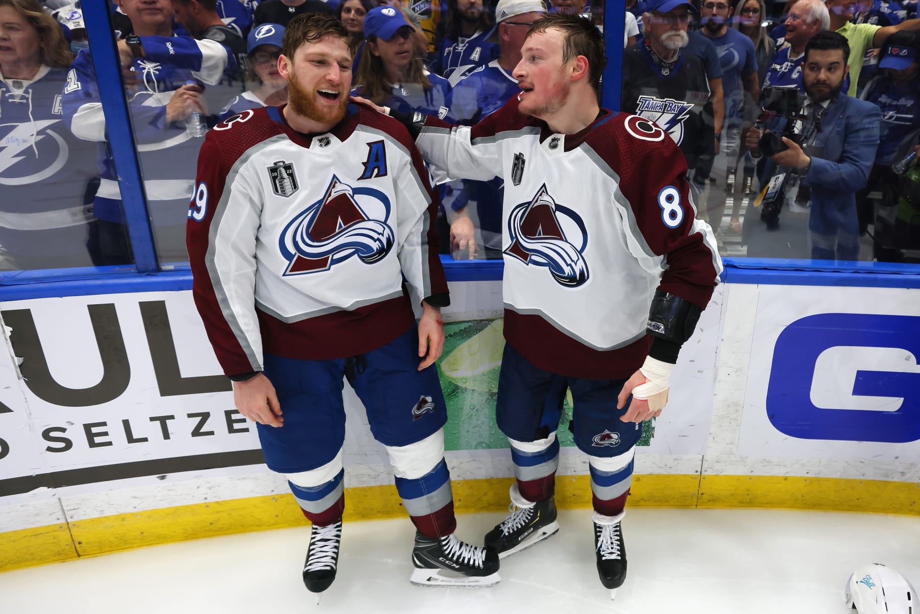 TAMPA, FLORIDA - JUNE 26: Nathan MacKinnon #29 and Cale Makar #8 of the Colorado Avalanche react after defeating the Tampa Bay Lightning 2-1 in Game Six of the 2022 NHL Stanley Cup Final at Amalie Arena on June 26, 2022 in Tampa, Florida. (Photo by Bruce Bennett/Getty Images)