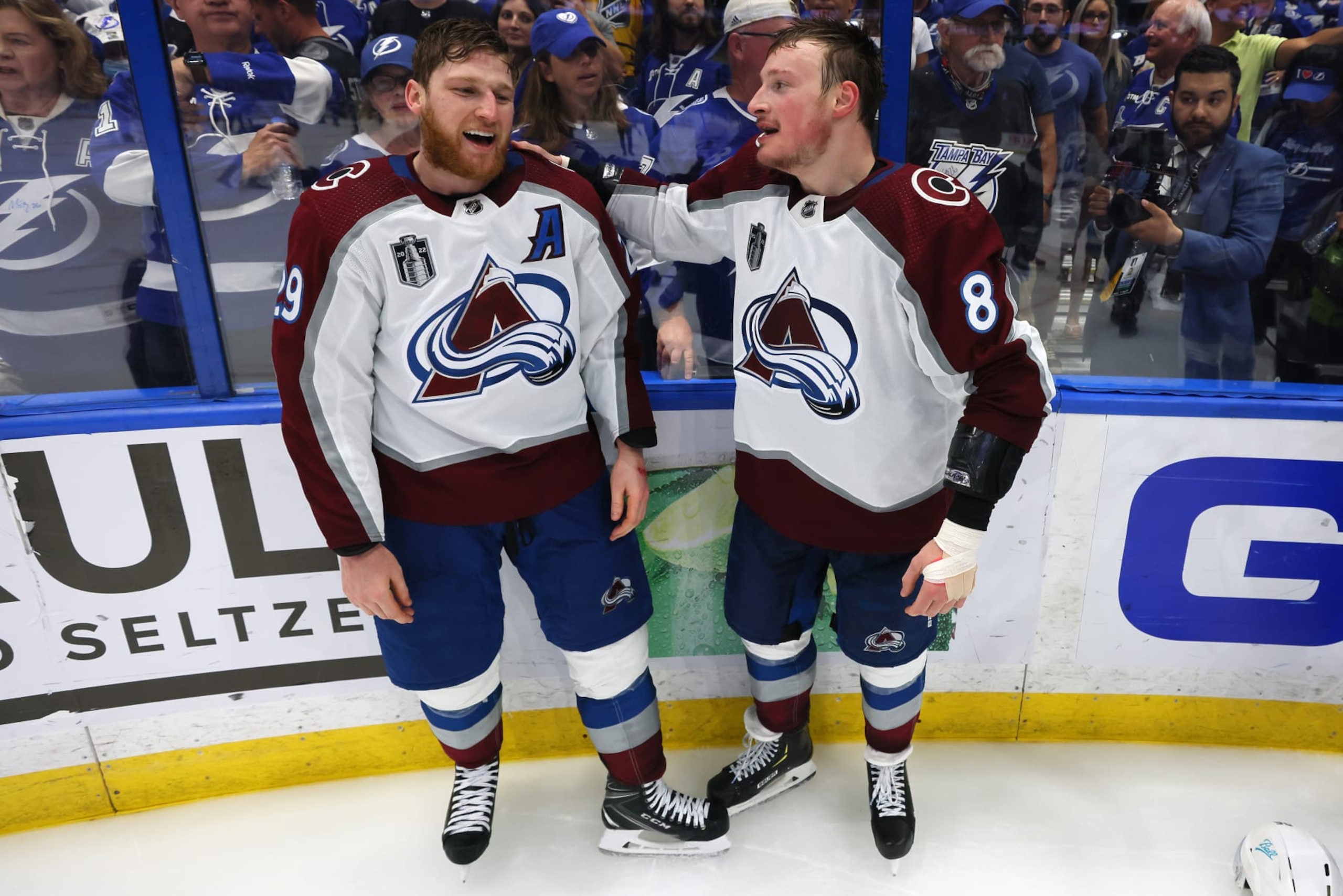 TAMPA, FLORIDA - JUNE 26: Nathan MacKinnon #29 and Cale Makar #8 of the Colorado Avalanche react after defeating the Tampa Bay Lightning 2-1 in Game Six of the 2022 NHL Stanley Cup Final at Amalie Arena on June 26, 2022 in Tampa, Florida. (Photo by Bruce Bennett/Getty Images)