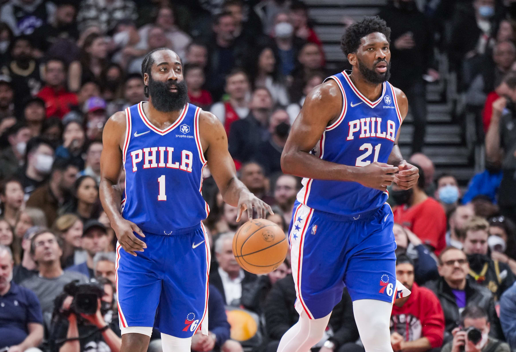 TORONTO, ON - APRIL 7: James Harden #1 of the Philadelphia 76ers brings the ball up the floor with Joel Embiid #21 against the Toronto Raptors during the first half of their basketball game at the Scotiabank Arena on April 7, 2022 in Toronto, Ontario, Canada. NOTE TO USER: User expressly acknowledges and agrees that, by downloading and/or using this Photograph, user is consenting to the terms and conditions of the Getty Images License Agreement. (Photo by Mark Blinch/Getty Images)