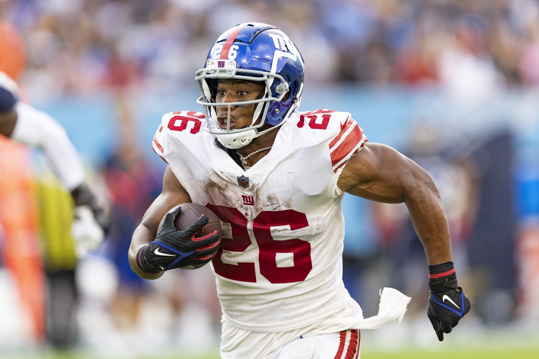 NASHVILLE, TENNESSEE - SEPTEMBER 11: Saquon Barkley #26 of the New York Giants runs the ball during a game against the Tennessee Titans at Nissan Stadium on September 11, 2022 in Nashville, Tennessee. The Giants defeated the Titans 21-20.  (Photo by Wesley Hitt/Getty Images)