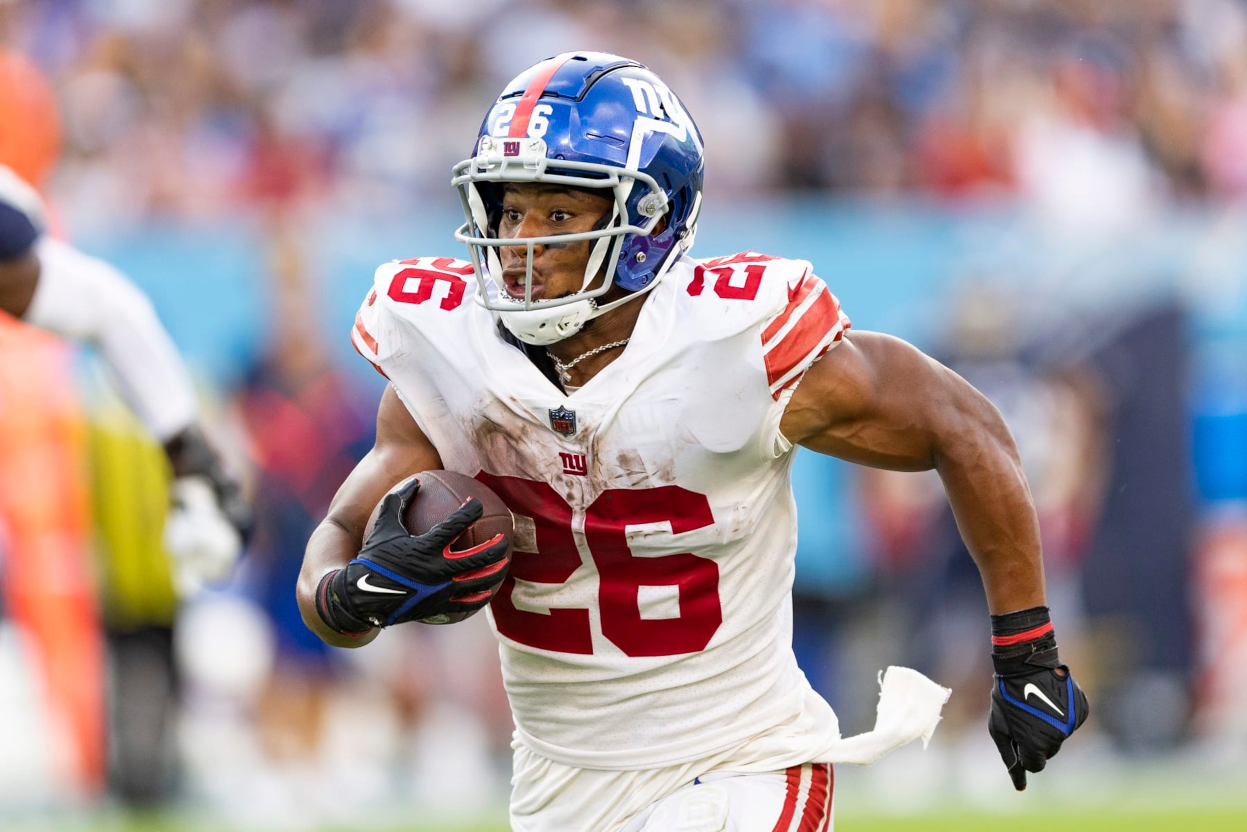 NASHVILLE, TENNESSEE - SEPTEMBER 11: Saquon Barkley #26 of the New York Giants runs the ball during a game against the Tennessee Titans at Nissan Stadium on September 11, 2022 in Nashville, Tennessee. The Giants defeated the Titans 21-20. (Photo by Wesley Hitt/Getty Images) NASHVILLE, TENNESSEE - SEPTEMBER 11: Saquon Barkley #26 of the New York Giants runs the ball during a game against the Tennessee Titans at Nissan Stadium on September 11, 2022 in Nashville, Tennessee. The Giants defeated the Titans 21-20. (Photo by Wesley Hitt/Getty Images)
