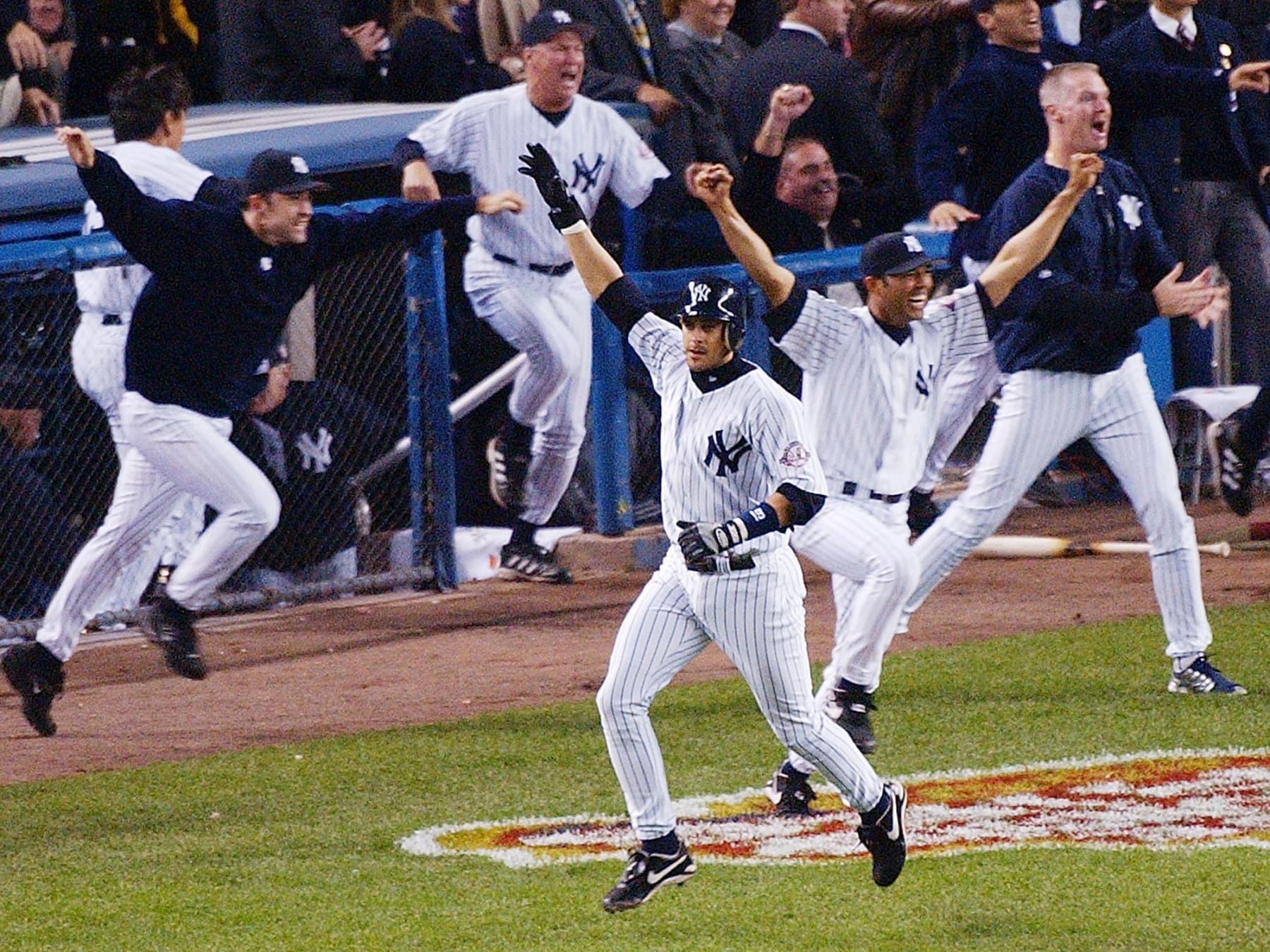 FILE - In this Oct. 16, 2003, file photo, New York Yankees' Aaron Boone, center, celebrates after hitting a solo home run in the 11th inning to beat the Boston Red Sox in Game 7 of the American League Championship Series in New York. Boone became the first person with no experience as a manager of coach to interview to become Joe Girardi's successor with the New York Yankees. The 44-year-old interviewed Friday, Nov. 17, 2017, becoming the fourth to go through the process after Yankees bench coach Rob Thomson, former Cleveland and Seattle manager Eric Wedge, and San Francisco bench coach Hensley Meulens. (AP Photo/Bill Kostroun, File)