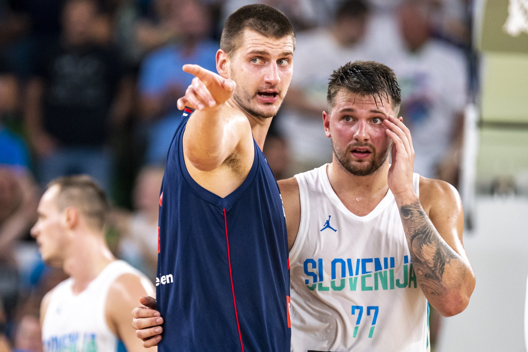 LJUBLJANA, SLOVENIA - AUGUST 17: Luka Doncic of Slovenia and Nikola Jokic of Serbia react during the basketball friendly match between Slovenia and Serbia in Arena Stozice, on August 17, 2022 in Ljubljana, Slovenia. (Photo by Jurij Kodrun/Getty Images)