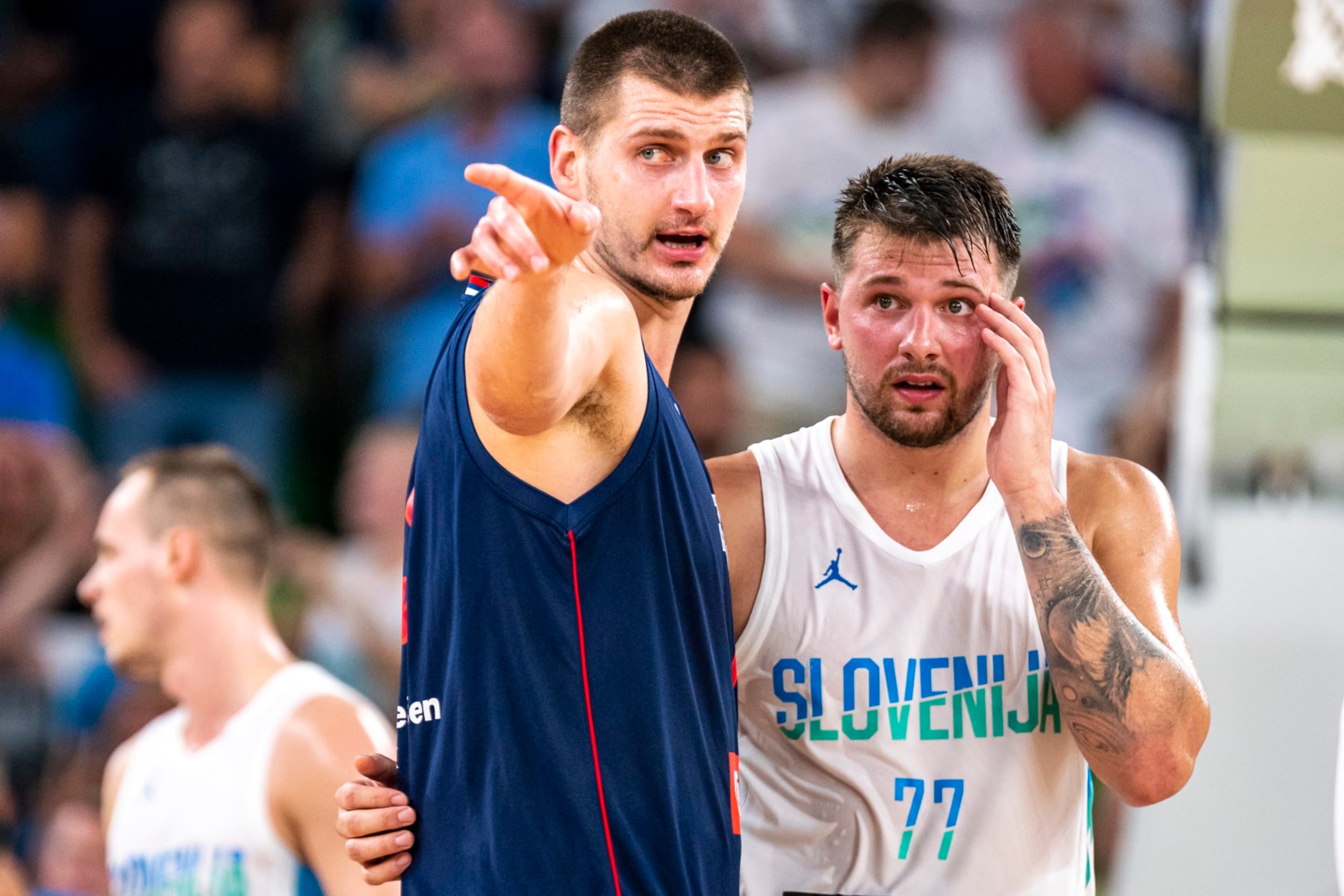 LJUBLJANA, SLOVENIA - AUGUST 17: Luka Doncic of Slovenia and Nikola Jokic of Serbia react during the basketball friendly match between Slovenia and Serbia in Arena Stozice, on August 17, 2022 in Ljubljana, Slovenia. (Photo by Jurij Kodrun/Getty Images)