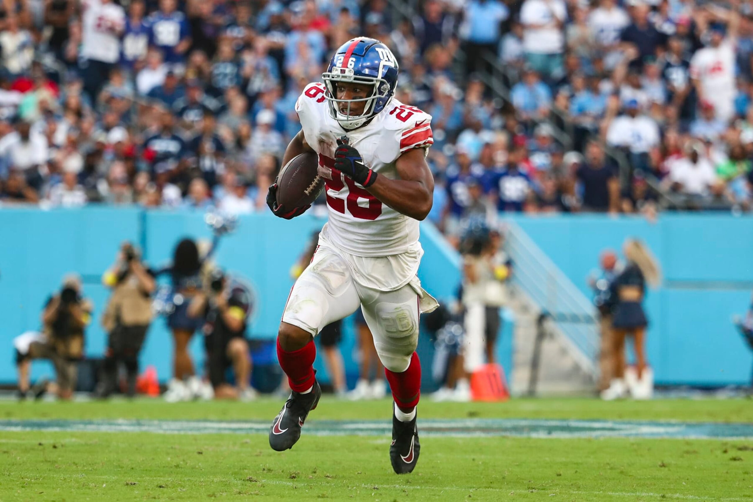 NASHVILLE, FL - SEPTEMBER 11: Saquon Barkley #26 of the New York Giants carries the ball during an NFL football game against the Tennessee Titans at Nissan Stadium on September 11, 2022 in Nashville, Tennessee. (Photo by Kevin Sabitus/Getty Images)