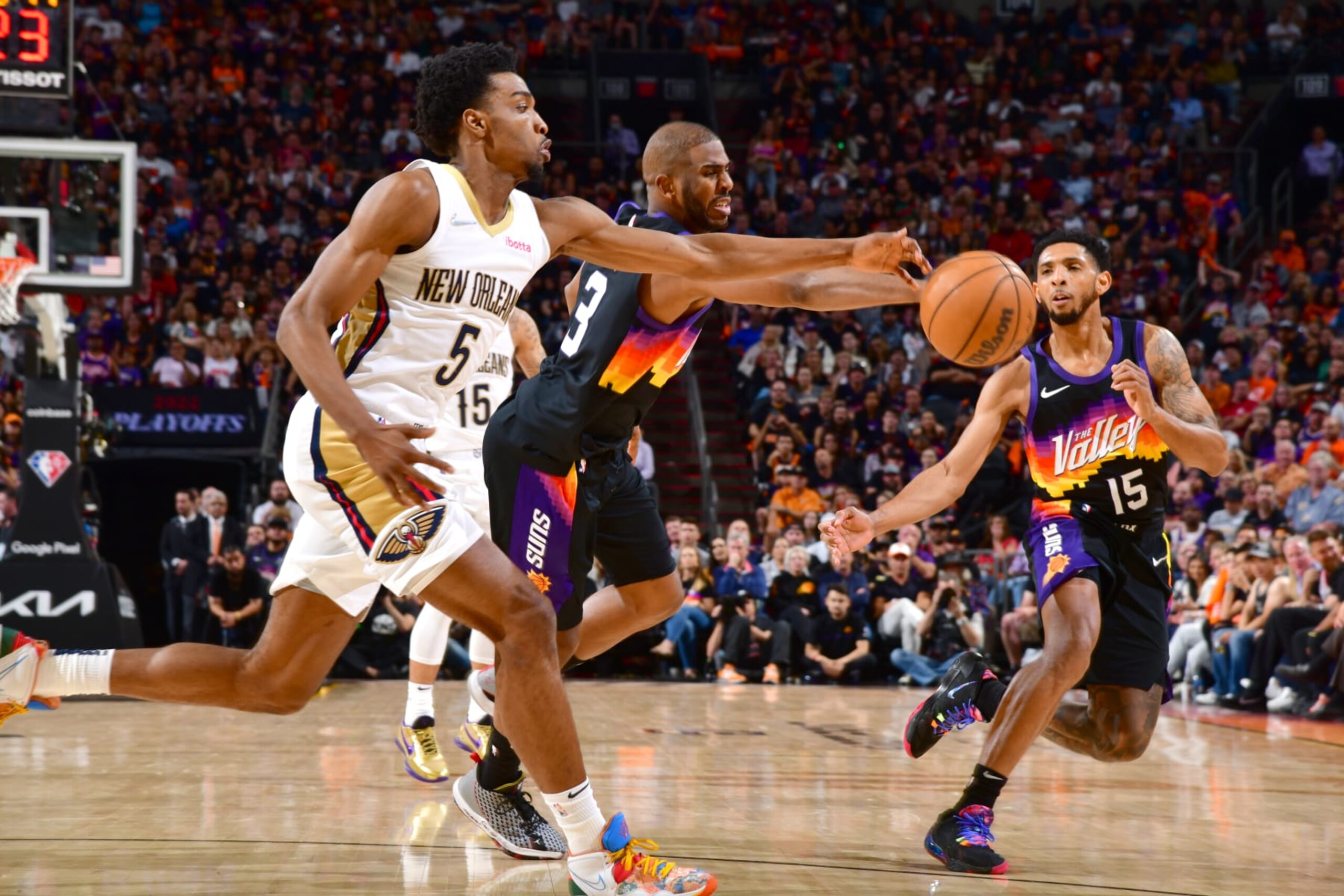 PHOENIX, AZ - APRIL 26: Herbert Jones #5 of the New Orleans Pelicans and Chris Paul #3 of the Phoenix Suns reach for the ball during Round 1 Game 5 of the 2022 NBA Playoffs on April 26, 2022 at Footprint Center in Phoenix, Arizona. NOTE TO USER: User expressly acknowledges and agrees that, by downloading and or using this photograph, user is consenting to the terms and conditions of the Getty Images License Agreement. Mandatory Copyright Notice: Copyright 2022 NBAE (Photo by Barry Gossage/NBAE via Getty Images)