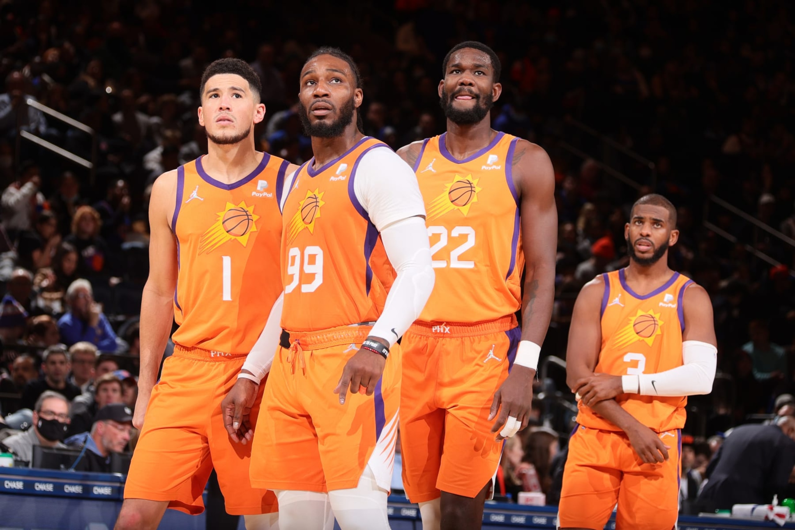 NEW YORK, NY - NOVEMBER 26: Devin Booker #1, Jae Crowder #99, Deandre Ayton #22 and Chris Paul #3 of the Phoenix Suns look on during the game against the New York Knicks on November 26, 2021 at Madison Square Garden in New York City, New York.  NOTE TO USER: User expressly acknowledges and agrees that, by downloading and or using this photograph, User is consenting to the terms and conditions of the Getty Images License Agreement. Mandatory Copyright Notice: Copyright 2021 NBAE  (Photo by Nathaniel S. Butler/NBAE via Getty Images)