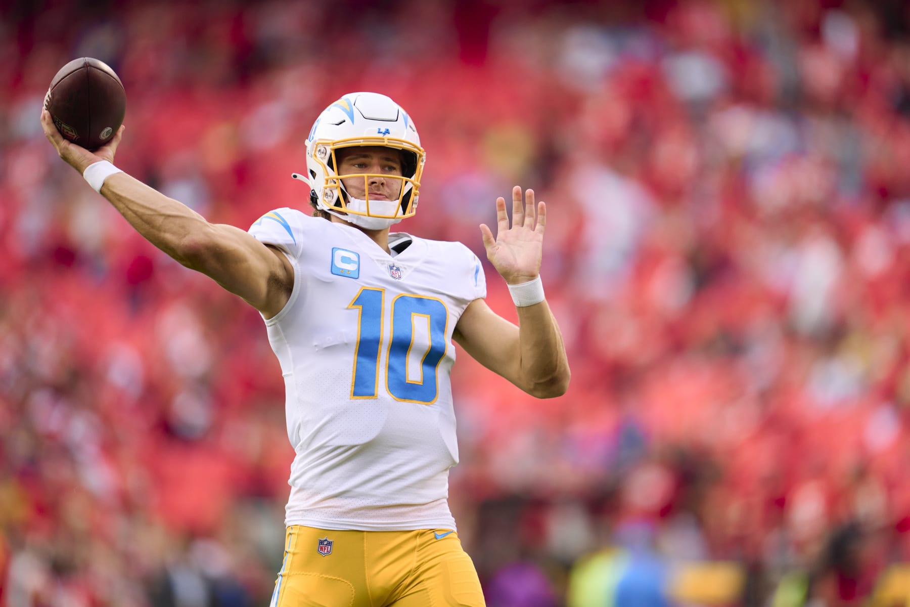 KANSAS CITY, MO - SEPTEMBER 15: Justin Herbert #10 of the Los Angeles Chargers warms up before kickoff against the Kansas City Chiefs at GEHA Field at Arrowhead Stadium on September 15, 2022 in Kansas City, Missouri. (Photo by Cooper Neill/Getty Images)