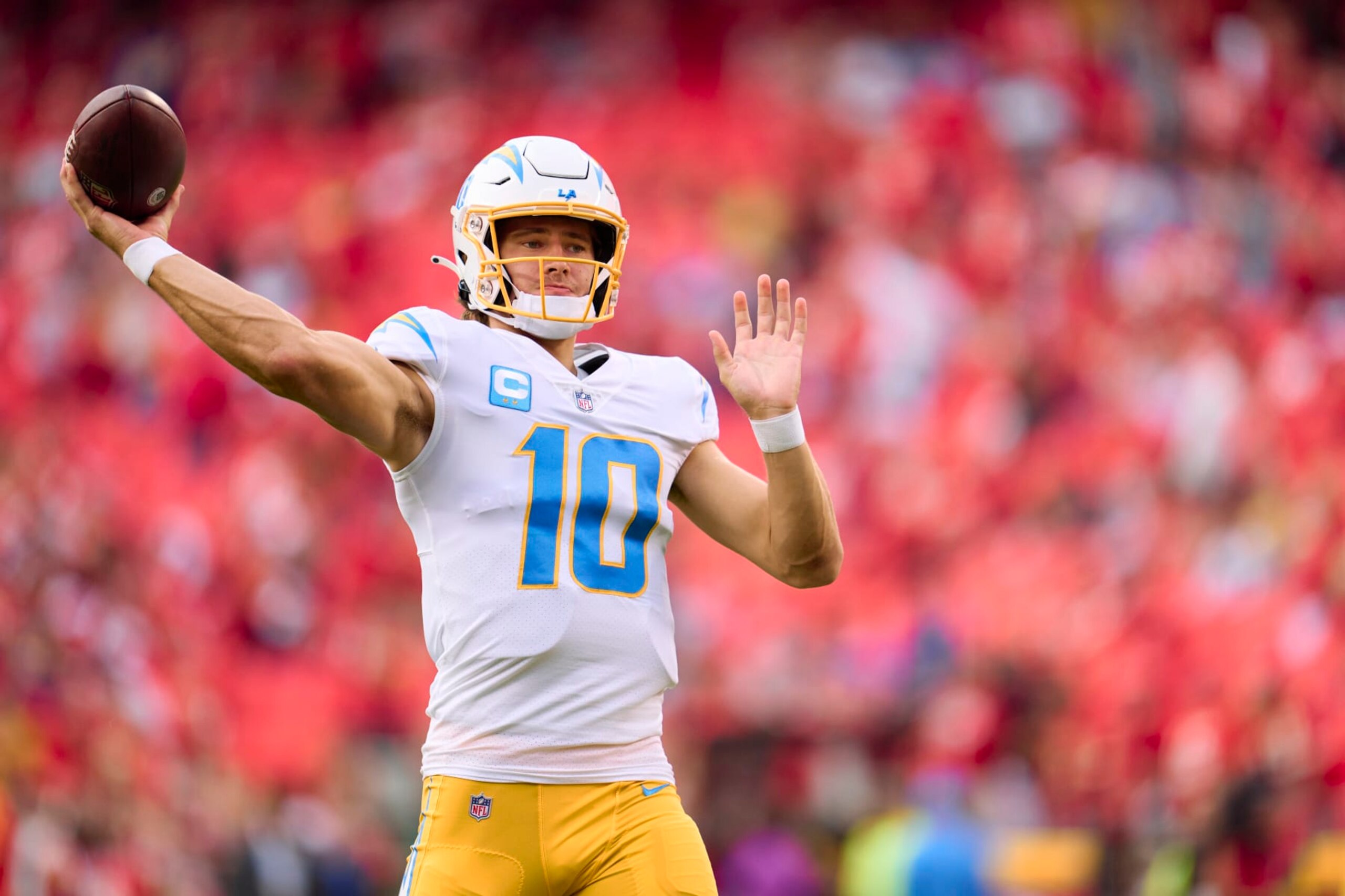KANSAS CITY, MO - SEPTEMBER 15: Justin Herbert #10 of the Los Angeles Chargers warms up before kickoff against the Kansas City Chiefs at GEHA Field at Arrowhead Stadium on September 15, 2022 in Kansas City, Missouri. (Photo by Cooper Neill/Getty Images)