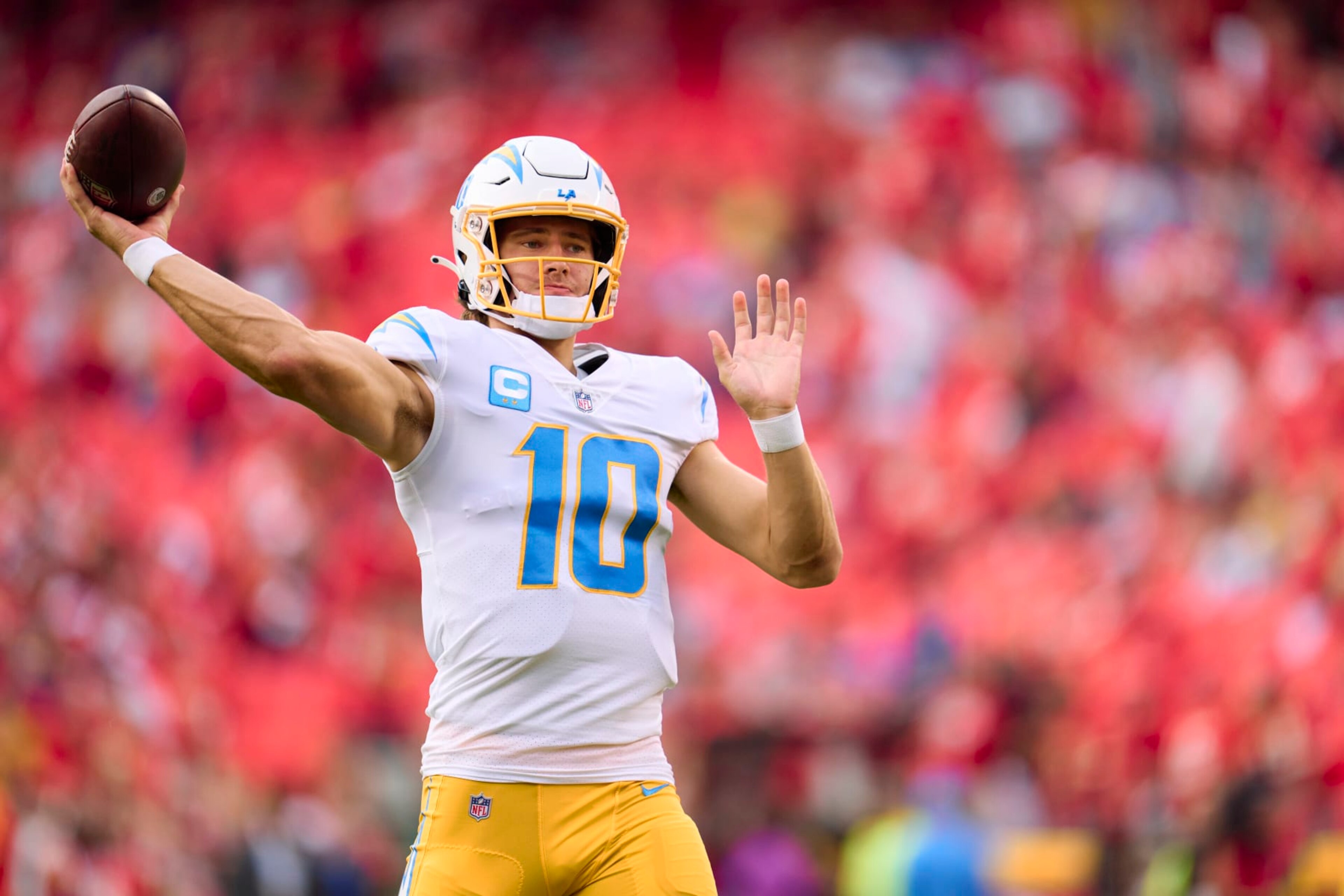 KANSAS CITY, MO - SEPTEMBER 15: Justin Herbert #10 of the Los Angeles Chargers warms up before kickoff against the Kansas City Chiefs at GEHA Field at Arrowhead Stadium on September 15, 2022 in Kansas City, Missouri. (Photo by Cooper Neill/Getty Images) KANSAS CITY, MO - SEPTEMBER 15: Justin Herbert #10 of the Los Angeles Chargers warms up before kickoff against the Kansas City Chiefs at GEHA Field at Arrowhead Stadium on September 15, 2022 in Kansas City, Missouri. (Photo by Cooper Neill/Getty Images)