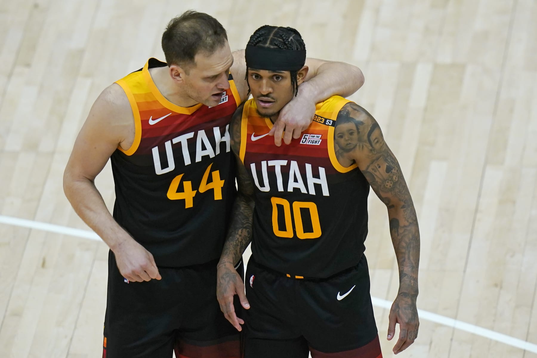 Utah Jazz's Bojan Bogdanovic (44) and Jordan Clarkson (00) huddle during the second half of Game 2 of a second-round NBA basketball playoff series Thursday, June 10, 2021, in Salt Lake City. (AP Photo/Rick Bowmer)