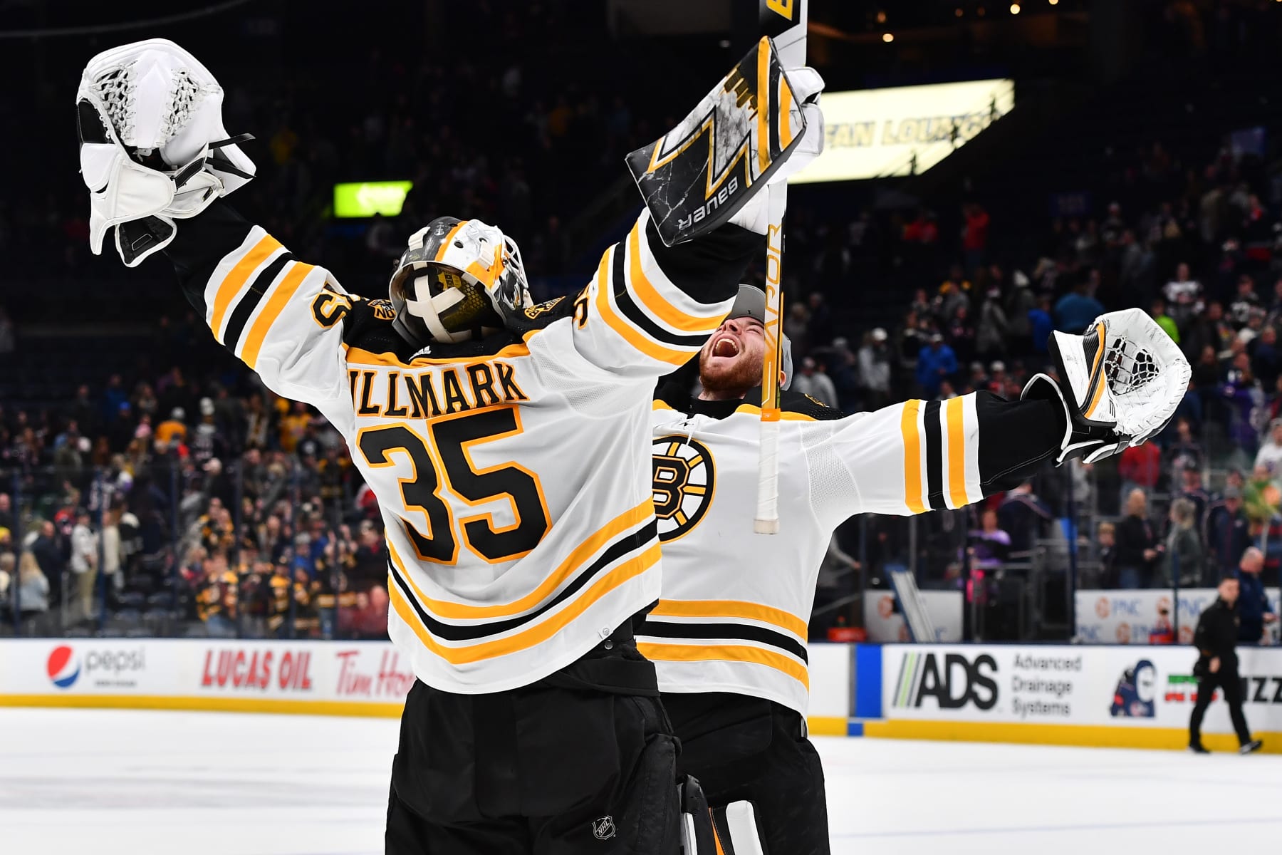 COLUMBUS, OH - APRIL 4: Linus Ullmark #35 and Jeremy Swayman #1 of the Boston Bruins celebrate a 3-2 win over the Columbus Blue Jackets in overtime at Nationwide Arena on April 4, 2022 in Columbus, Ohio.  (Photo by Ben Jackson/NHLI via Getty Images)