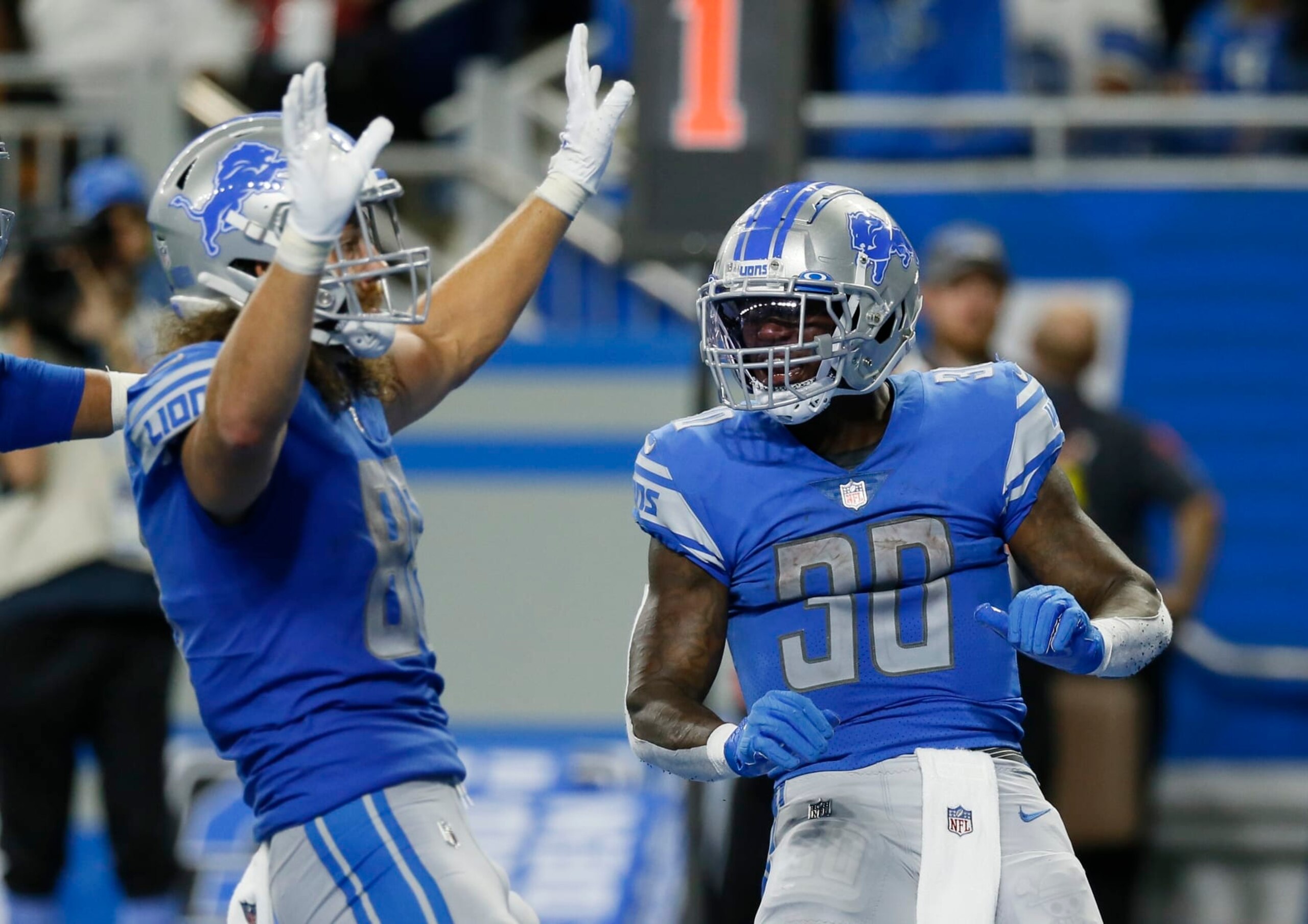 Detroit Lions running back Jamaal Williams (30) celebrates his touchdown with tight end T.J. Hockenson in the second half of an NFL football game against the Philadelphia Eagles in Detroit, Sunday, Sept. 11, 2022. (AP Photo/Duane Burleson)
