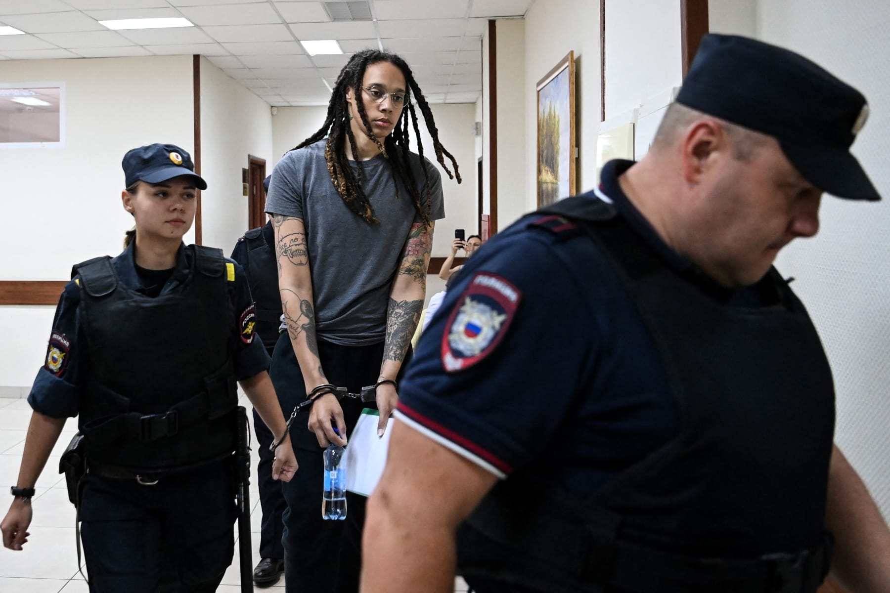 US Women National Basketball Association's (WNBA) basketball player Brittney Griner, who was detained at Moscow's Sheremetyevo airport and later charged with illegal possession of cannabis, is escorted to the courtroom to hear the court's final decision in Khimki outside Moscow, on August 4, 2022. - Russian prosecutors requested that US basketball star Brittney Griner be sentenced to nine and a half years in prison on drug smuggling charges. Her hearing comes with tensions soaring between Moscow and Washington over Russia's military intervention in Ukraine that has sparked international condemnation and a litany of Western sanctions. (Photo by Kirill KUDRYAVTSEV / AFP) (Photo by KIRILL KUDRYAVTSEV/AFP via Getty Images)
