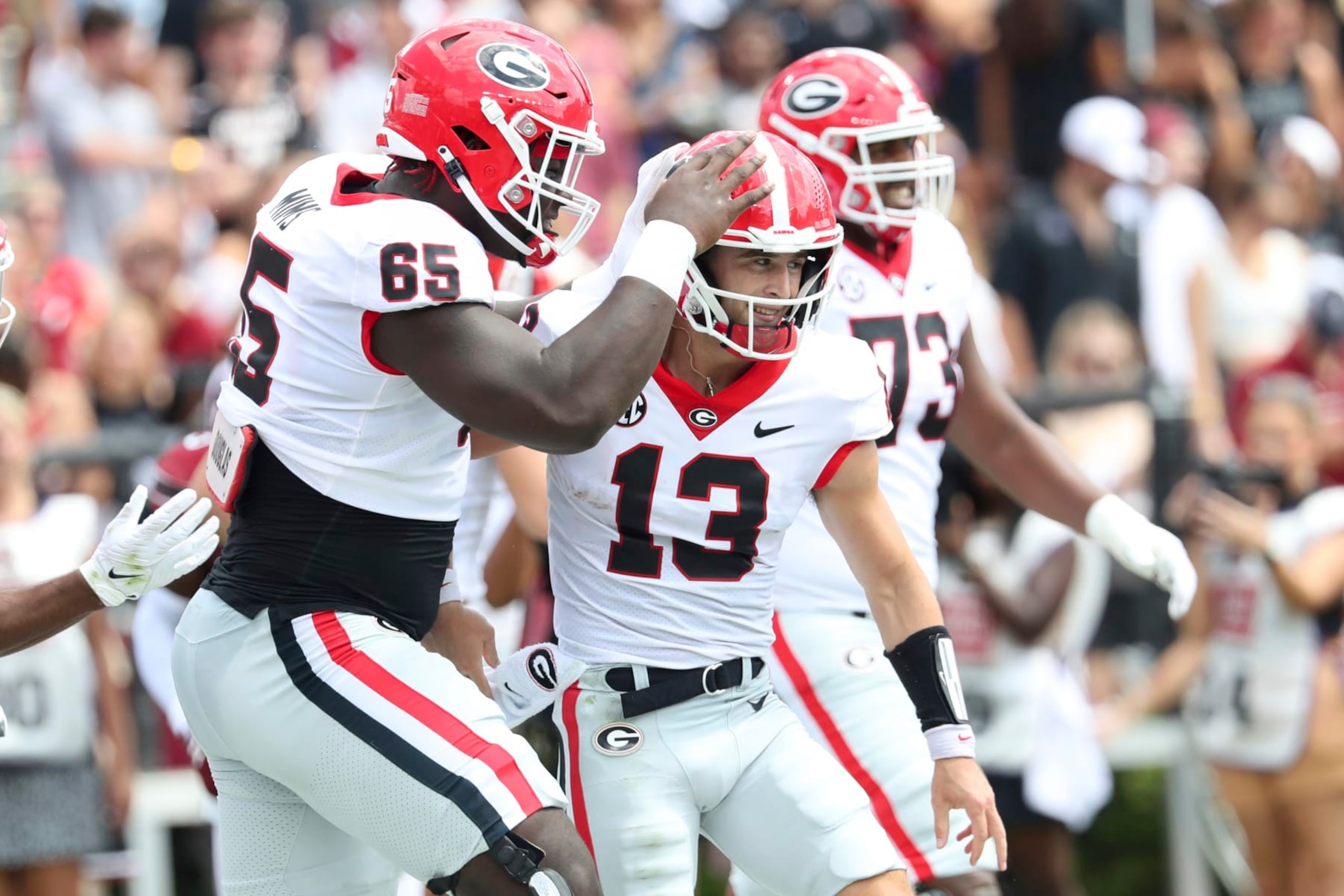 Georgia offensive lineman Amarius Mims (65) congratulates quarterback Stetson Bennett (13) during the first half of an NCAA college football game against South Carolina on Saturday, Sept. 17, 2022, in Columbia, S.C. (AP Photo/Artie Walker Jr.) Georgia offensive lineman Amarius Mims (65) congratulates quarterback Stetson Bennett (13) during the first half of an NCAA college football game against South Carolina on Saturday, Sept. 17, 2022, in Columbia, S.C. (AP Photo/Artie Walker Jr.)