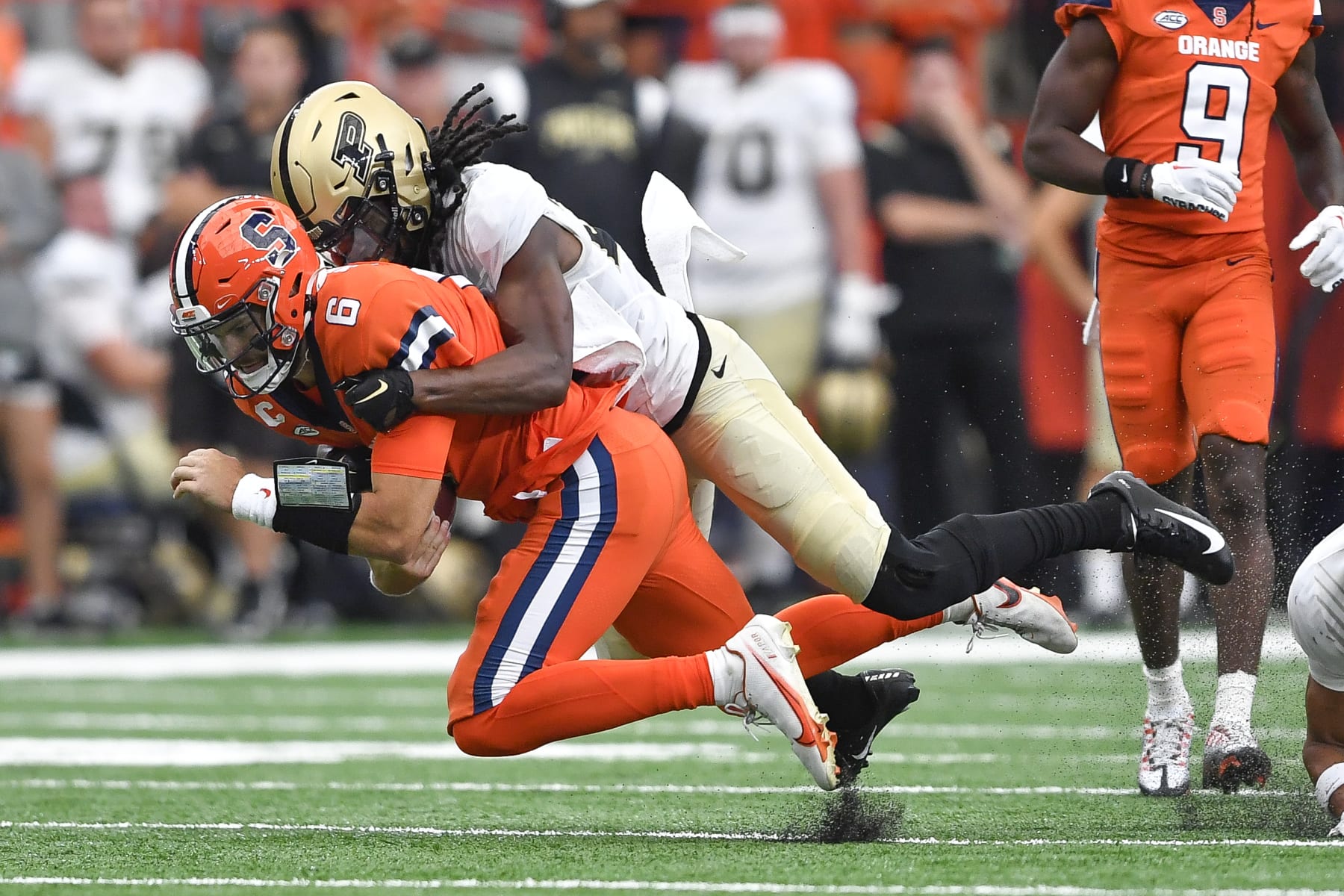 Syracuse quarterback Garrett Shrader, left, is tackled by Purdue cornerback Cory Trice during the first half of an NCAA college football game in Syracuse, N.Y., Saturday, Sept. 17, 2022. (AP Photo/Adrian Kraus)