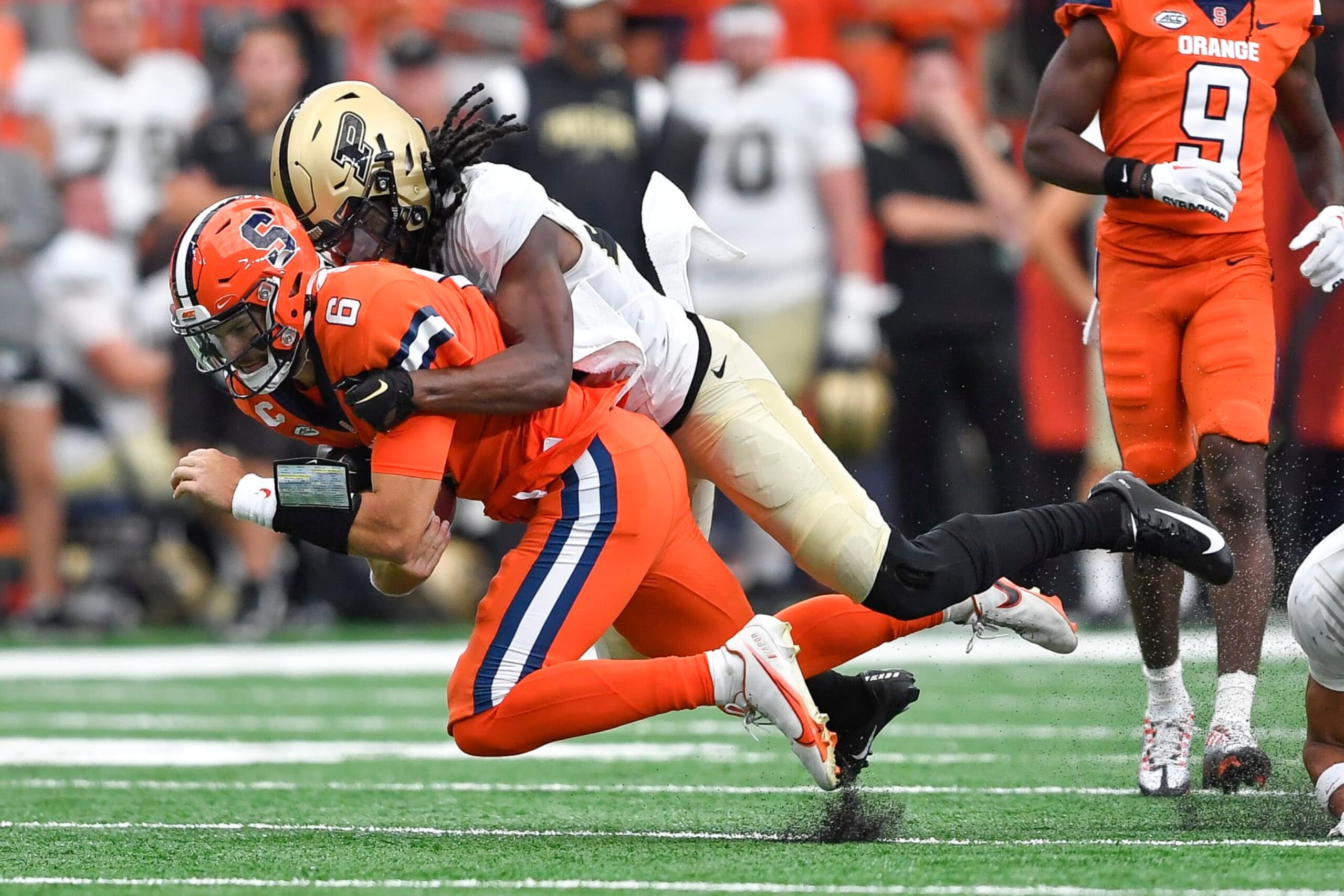 Syracuse quarterback Garrett Shrader, left, is tackled by Purdue cornerback Cory Trice during the first half of an NCAA college football game in Syracuse, N.Y., Saturday, Sept. 17, 2022. (AP Photo/Adrian Kraus) Syracuse quarterback Garrett Shrader, left, is tackled by Purdue cornerback Cory Trice during the first half of an NCAA college football game in Syracuse, N.Y., Saturday, Sept. 17, 2022. (AP Photo/Adrian Kraus)