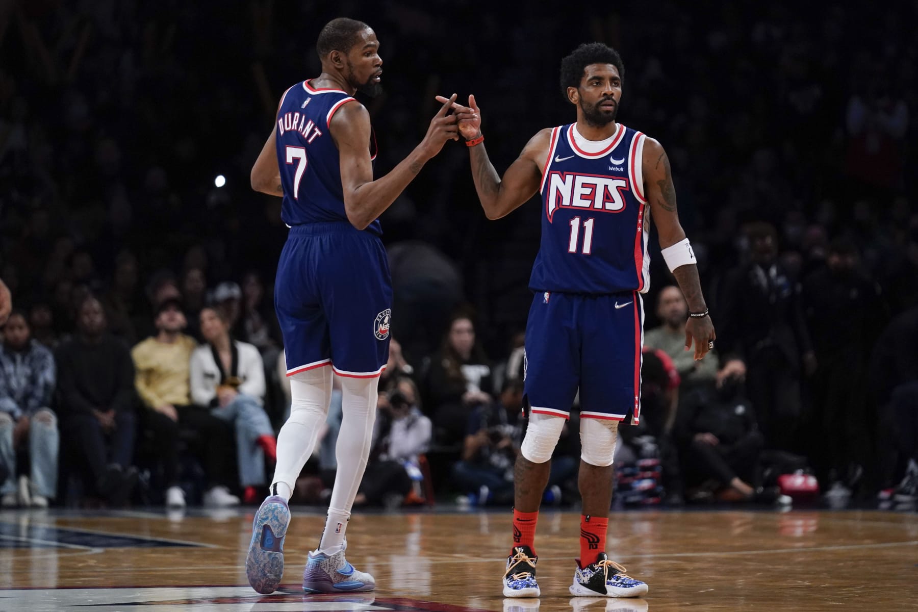 Brooklyn Nets' Kyrie Irving, right, and Kevin Durant celebrate after a basket during the second half of an NBA basketball game against the Indiana Pacers at the Barclays Center, Sunday, April 10, 2022, in New York. The Nets defeated the Pacers 134-126. (AP Photo/Seth Wenig)