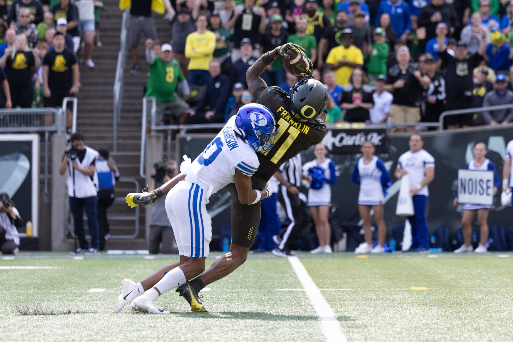 EUGENE, OR - SEPTEMBER 17: Wide receiver Troy Franklin #11 of the Oregon Ducks catches  a pass over defensive back Jakob Robinson #0 of the Brigham Young Cougars during the first half at Autzen Stadium on September 17, 2022 in Eugene, Oregon. (Photo by Tom Hauck/Getty Images)
