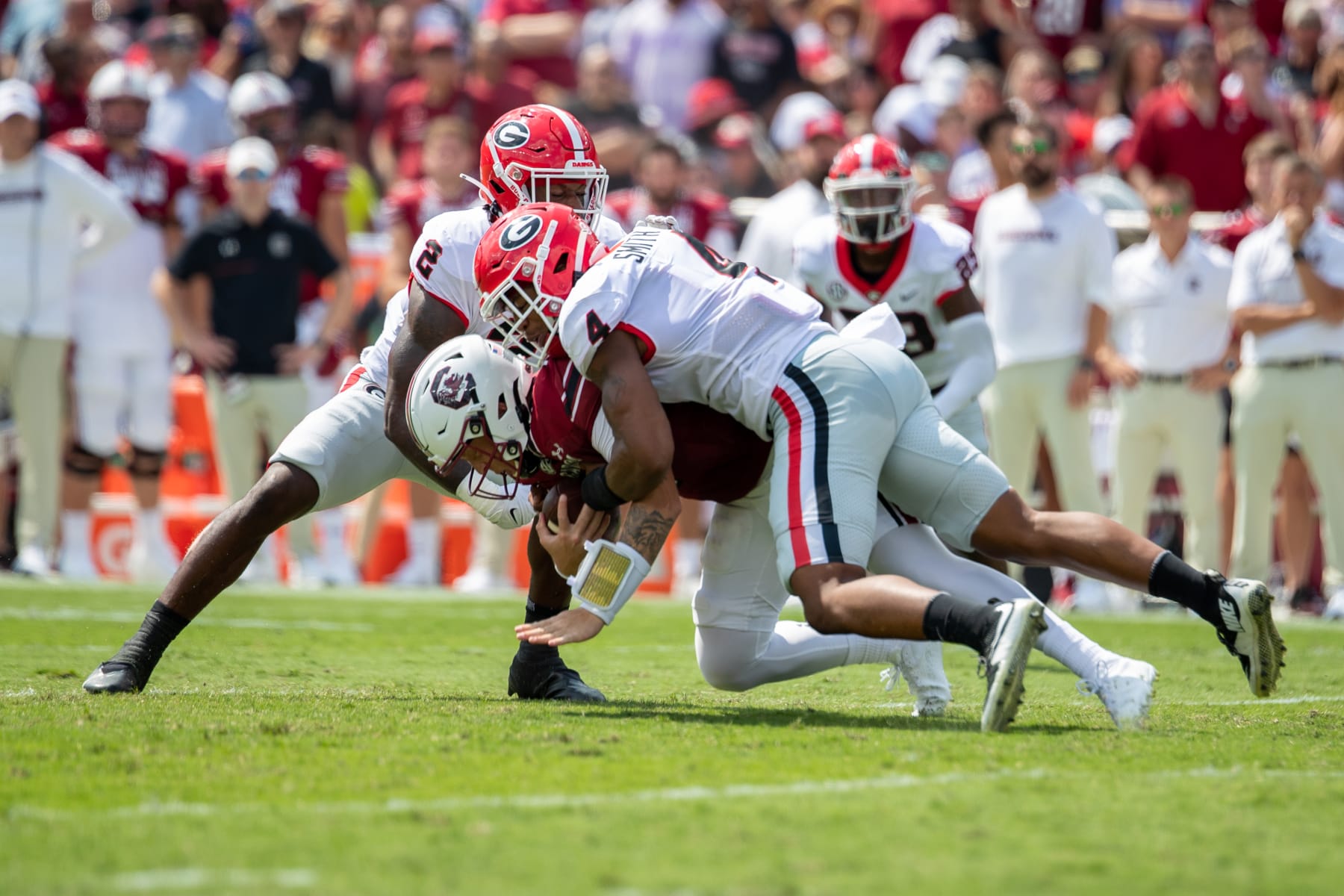 COLUMBIA, SC - SEPTEMBER 17: Georgia Bulldogs linebacker Nolan Smith (4) and Georgia Bulldogs linebacker Smael Mondon Jr. (2) tackle South Carolina Gamecocks quarterback Spencer Rattler (7) during a football game between the Georgia Bulldogs and the South Carolina Gamecocks on September 17, 2022, at Williams-Brice Stadium in Columbia, SC. (Photo by Charles Brock/Icon Sportswire via Getty Images)