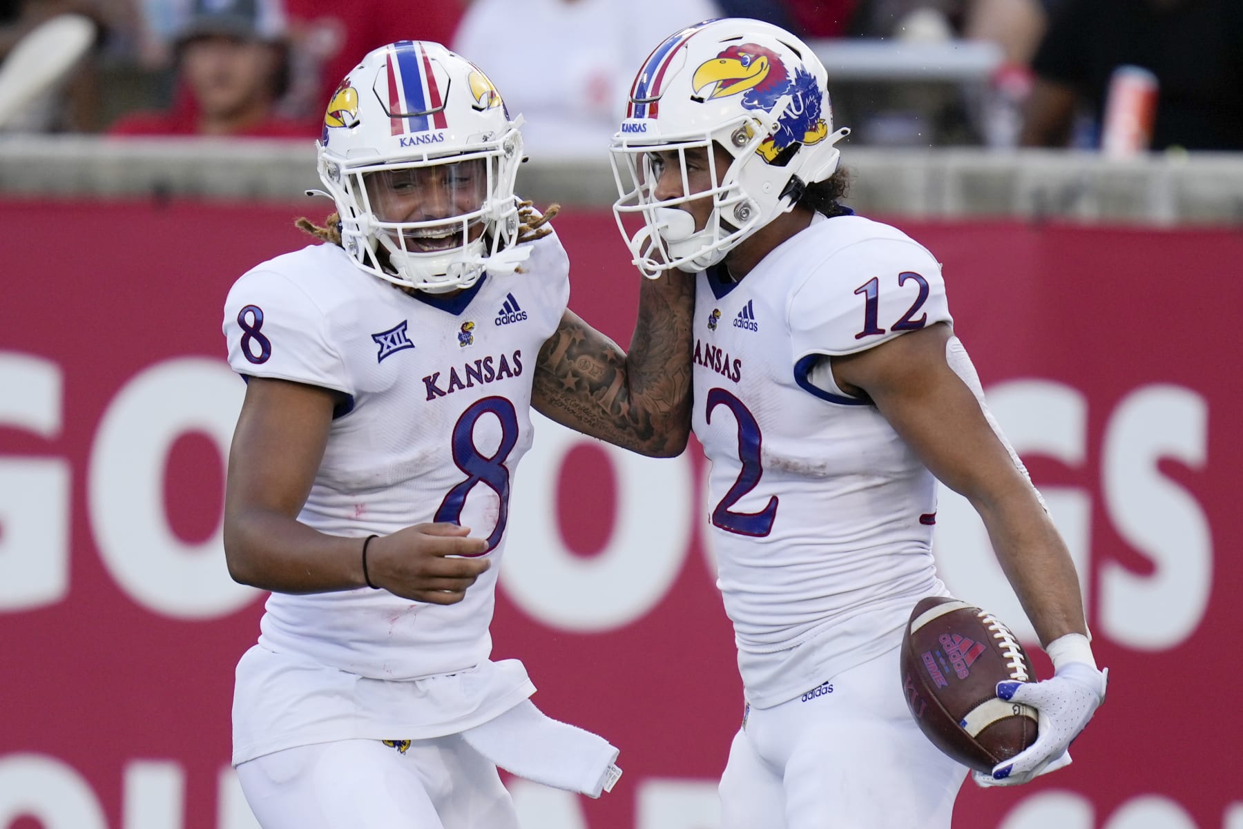 Kansas running back Torry Locklin (12) celebrates after his touchdown with Ky Thomas during the first half of an NCAA college football game against Houston, Saturday, Sept. 17, 2022, in Houston. (AP Photo/Eric Christian Smith)