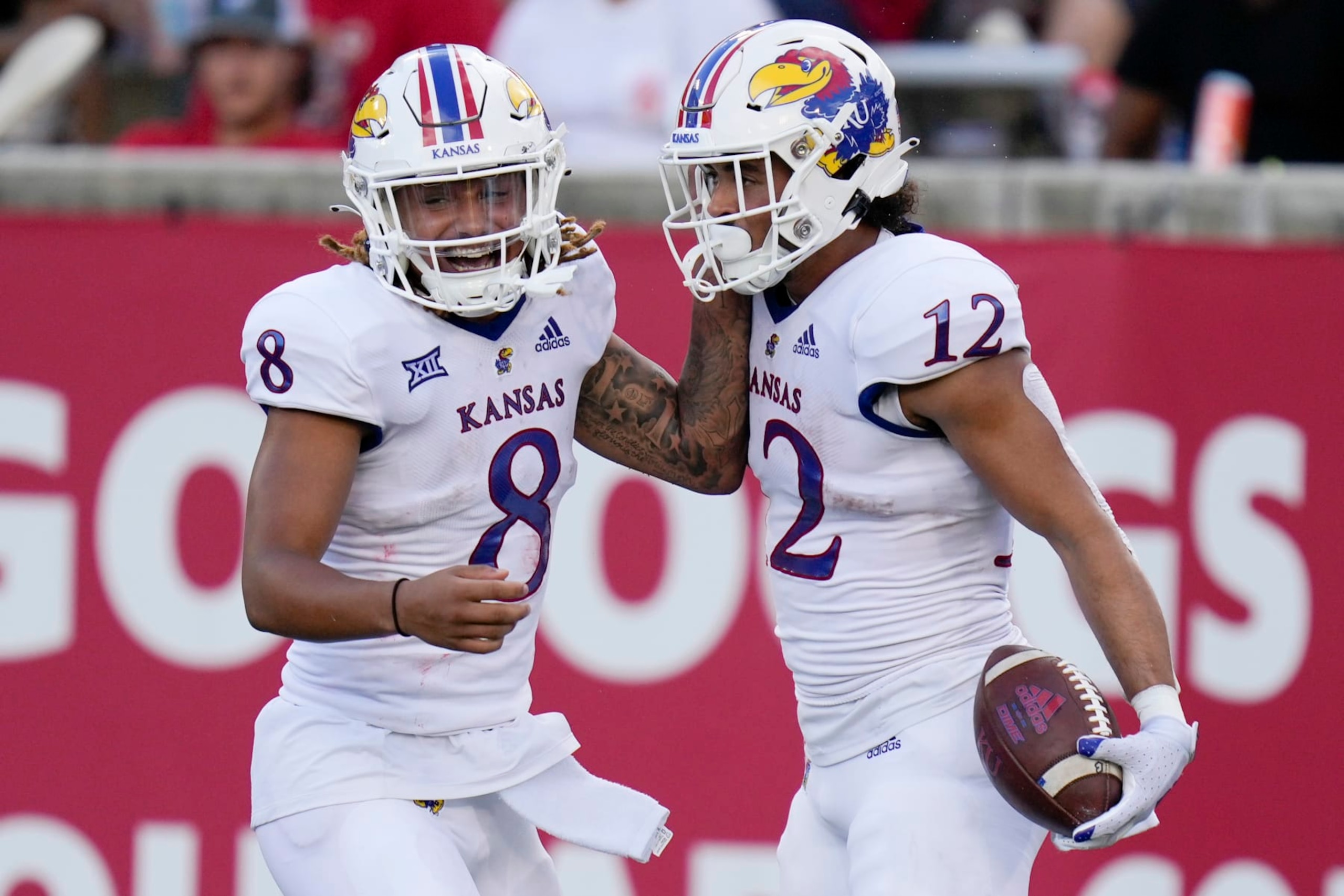 Kansas running back Torry Locklin (12) celebrates after his touchdown with Ky Thomas during the first half of an NCAA college football game against Houston, Saturday, Sept. 17, 2022, in Houston. (AP Photo/Eric Christian Smith) Kansas running back Torry Locklin (12) celebrates after his touchdown with Ky Thomas during the first half of an NCAA college football game against Houston, Saturday, Sept. 17, 2022, in Houston. (AP Photo/Eric Christian Smith)
