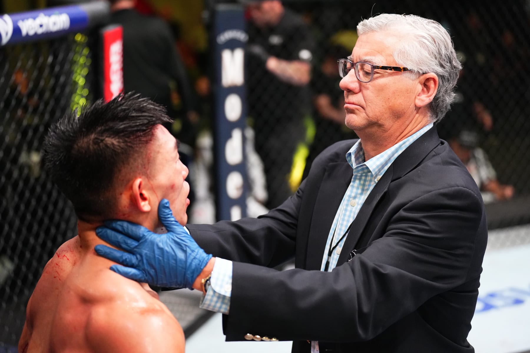 LAS VEGAS, NEVADA - SEPTEMBER 17: A doctor inspects the cut of Song Yadong of China during a stoppage against Cory Sandhagen in a bantamweight fight during the UFC Fight Night event at UFC APEX on September 17, 2022 in Las Vegas, Nevada. (Photo by Chris Unger/Zuffa LLC)