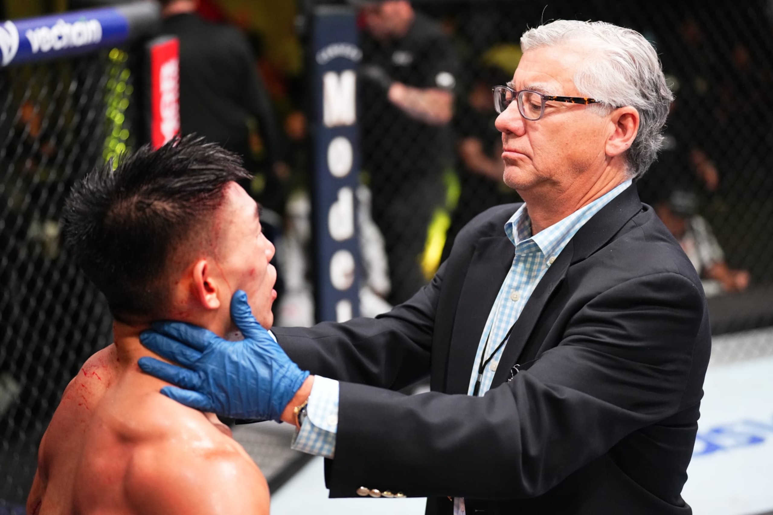 LAS VEGAS, NEVADA - SEPTEMBER 17: A doctor inspects the cut of Song Yadong of China during a stoppage against Cory Sandhagen in a bantamweight fight during the UFC Fight Night event at UFC APEX on September 17, 2022 in Las Vegas, Nevada. (Photo by Chris Unger/Zuffa LLC)