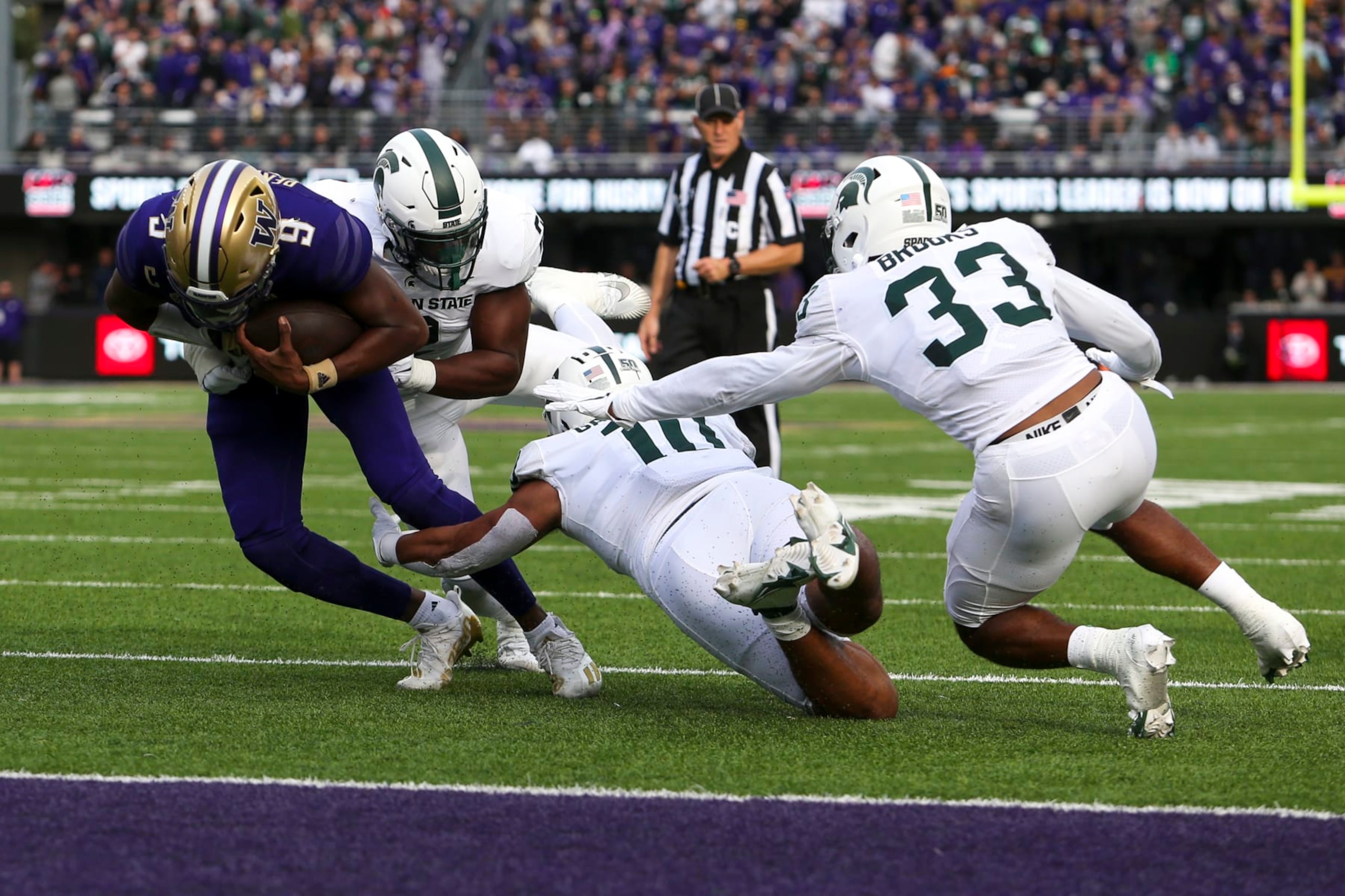 SEATTLE, WA - SEPTEMBER 17: Michigan State Spartans linebacker Quavian Carter (11) and Michigan State Spartans defensive end Khris Bogle (2) tackle Washington Huskies quarterback Michael Penix Jr. (9) short of the end zone during a college football game between the Michigan State Spartans and the Washington Huskies on September 17, 2022, at Husky Stadium in Seattle, WA. (Photo by Jacob Snow/Icon Sportswire via Getty Images) SEATTLE, WA - SEPTEMBER 17: Michigan State Spartans linebacker Quavian Carter (11) and Michigan State Spartans defensive end Khris Bogle (2) tackle Washington Huskies quarterback Michael Penix Jr. (9) short of the end zone during a college football game between the Michigan State Spartans and the Washington Huskies on September 17, 2022, at Husky Stadium in Seattle, WA. (Photo by Jacob Snow/Icon Sportswire via Getty Images)