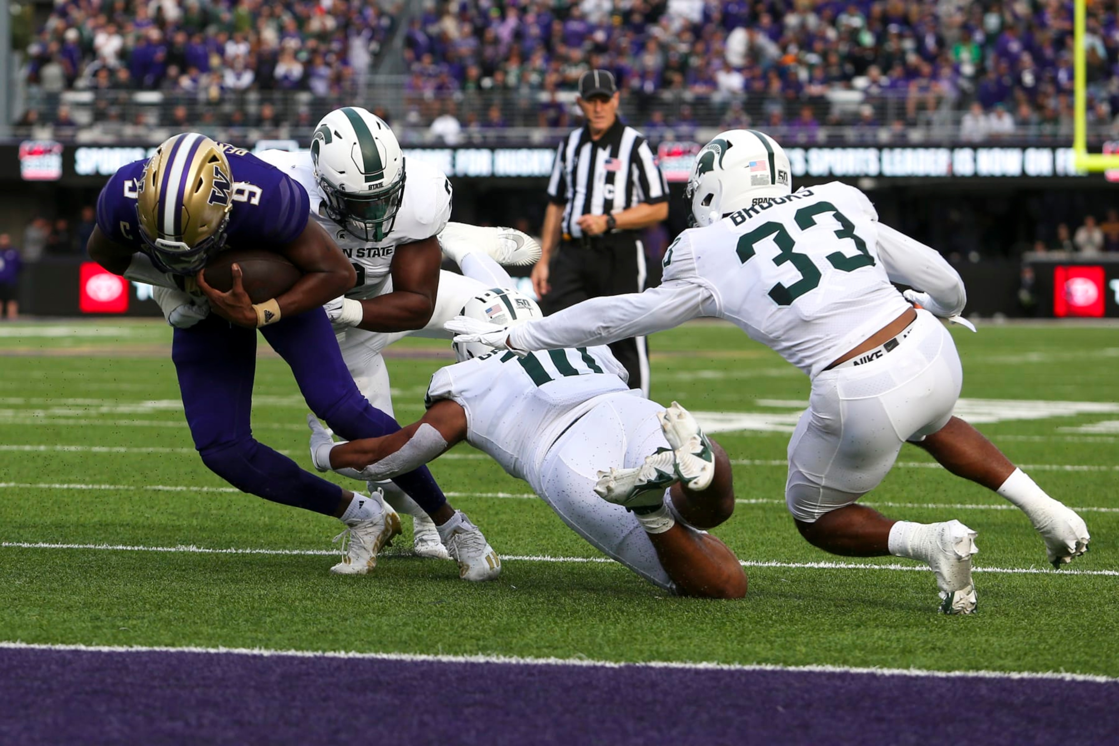 SEATTLE, WA - SEPTEMBER 17: Michigan State Spartans linebacker Quavian Carter (11) and Michigan State Spartans defensive end Khris Bogle (2) tackle Washington Huskies quarterback Michael Penix Jr. (9) short of the end zone during a college football game between the Michigan State Spartans and the Washington Huskies on September 17, 2022, at Husky Stadium in Seattle, WA. (Photo by Jacob Snow/Icon Sportswire via Getty Images) SEATTLE, WA - SEPTEMBER 17: Michigan State Spartans linebacker Quavian Carter (11) and Michigan State Spartans defensive end Khris Bogle (2) tackle Washington Huskies quarterback Michael Penix Jr. (9) short of the end zone during a college football game between the Michigan State Spartans and the Washington Huskies on September 17, 2022, at Husky Stadium in Seattle, WA. (Photo by Jacob Snow/Icon Sportswire via Getty Images)