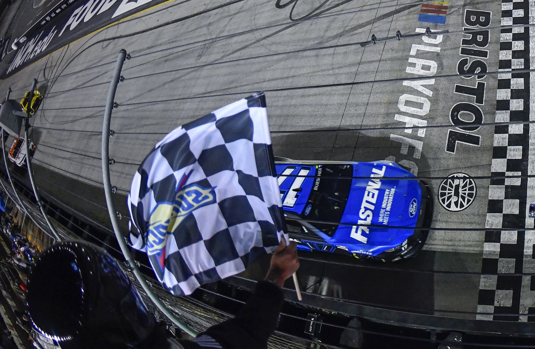 BRISTOL, TENNESSEE - SEPTEMBER 17: Chris Buescher, driver of the #17 Fastenal Ford, takes the checkered flag to win the NASCAR Cup Series Bass Pro Shops Night Race at Bristol Motor Speedway on September 17, 2022 in Bristol, Tennessee. (Photo by Logan Riely/Getty Images)