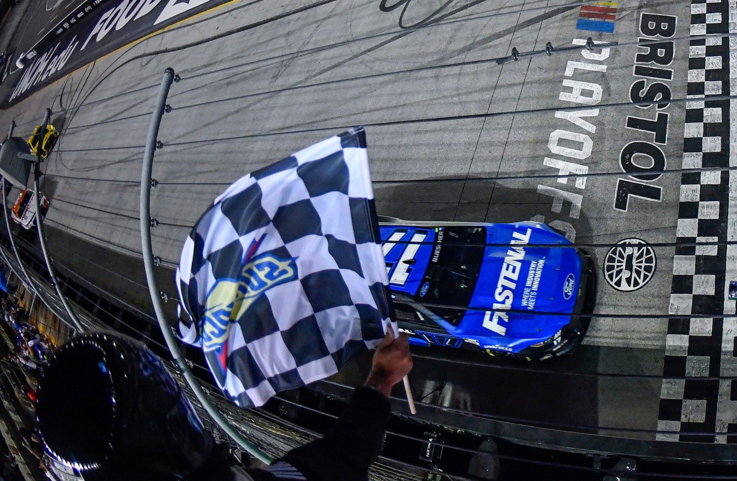 BRISTOL, TENNESSEE - SEPTEMBER 17: Chris Buescher, driver of the #17 Fastenal Ford, takes the checkered flag to win the NASCAR Cup Series Bass Pro Shops Night Race at Bristol Motor Speedway on September 17, 2022 in Bristol, Tennessee. (Photo by Logan Riely/Getty Images)