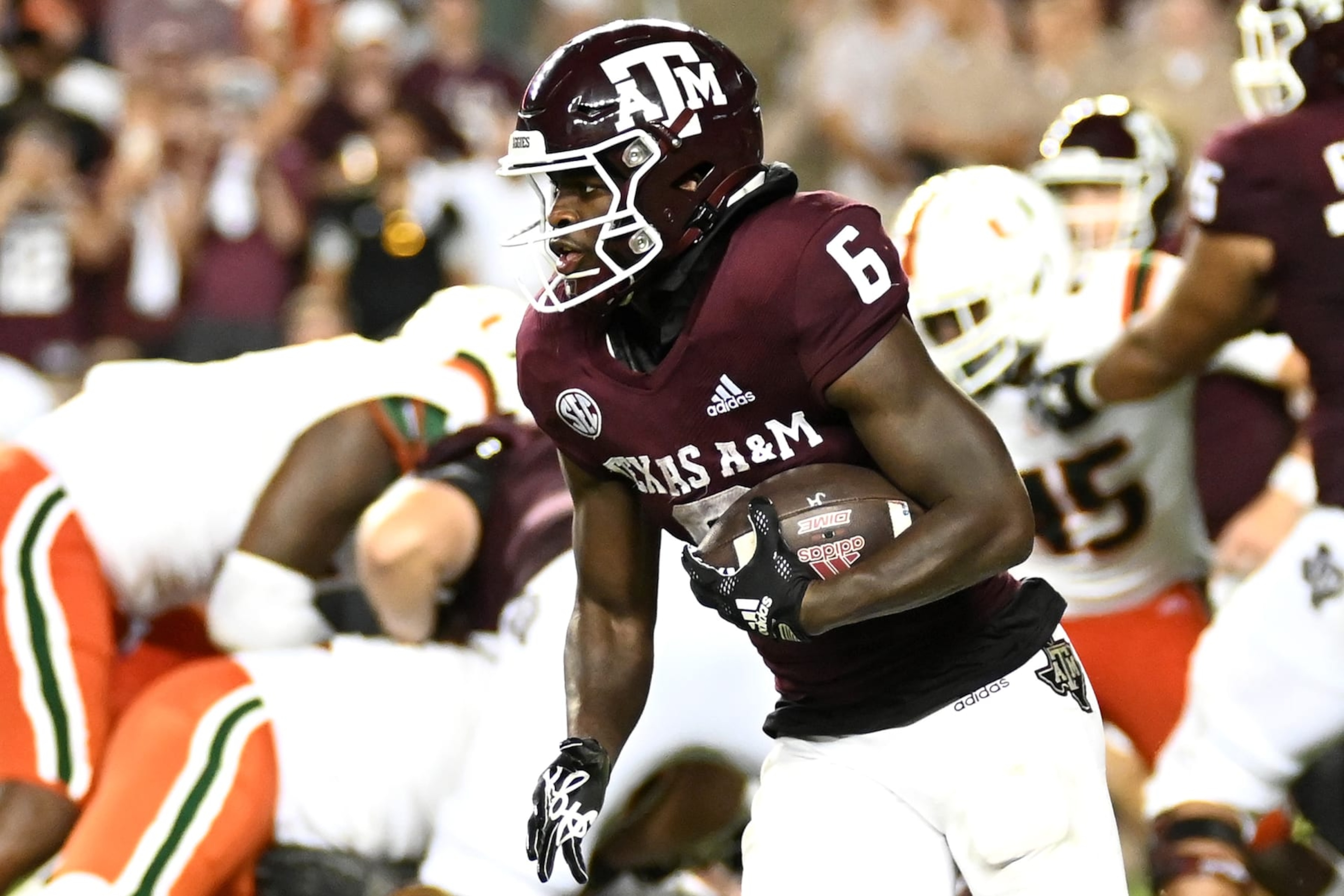 COLLEGE STATION, TEXAS - SEPTEMBER 17: Devon Achane #6 of the Texas A&M Aggies runs the ball against the Miami Hurricanes during the second half of the game at Kyle Field on September 17, 2022 in College Station, Texas. (Photo by Jack Gorman/Getty Images) COLLEGE STATION, TEXAS - SEPTEMBER 17: Devon Achane #6 of the Texas A&M Aggies runs the ball against the Miami Hurricanes during the second half of the game at Kyle Field on September 17, 2022 in College Station, Texas. (Photo by Jack Gorman/Getty Images)