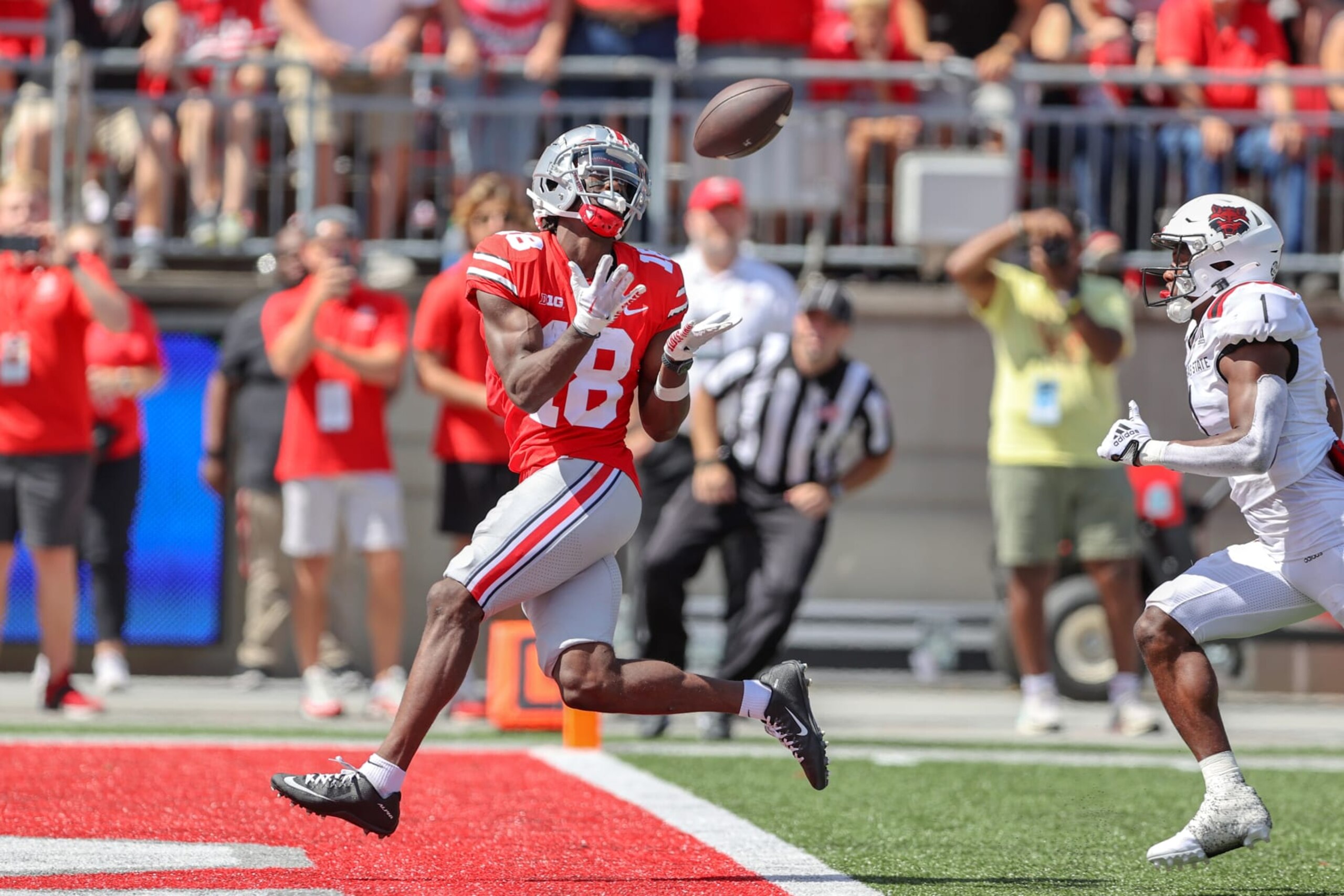 COLUMBUS, OH - SEPTEMBER 10: Ohio State Buckeyes wide receiver Marvin Harrison Jr. (18) scores on a 42-yard touchdown pass as Arkansas State Red Wolves cornerback Samy Johnson (1) defends during the second quarter of the college football game between the Arkansas State Red Wolves and Ohio State Buckeyes on September 10, 2022, at Ohio Stadium in Columbus, OH. (Photo by Frank Jansky/Icon Sportswire via Getty Images)