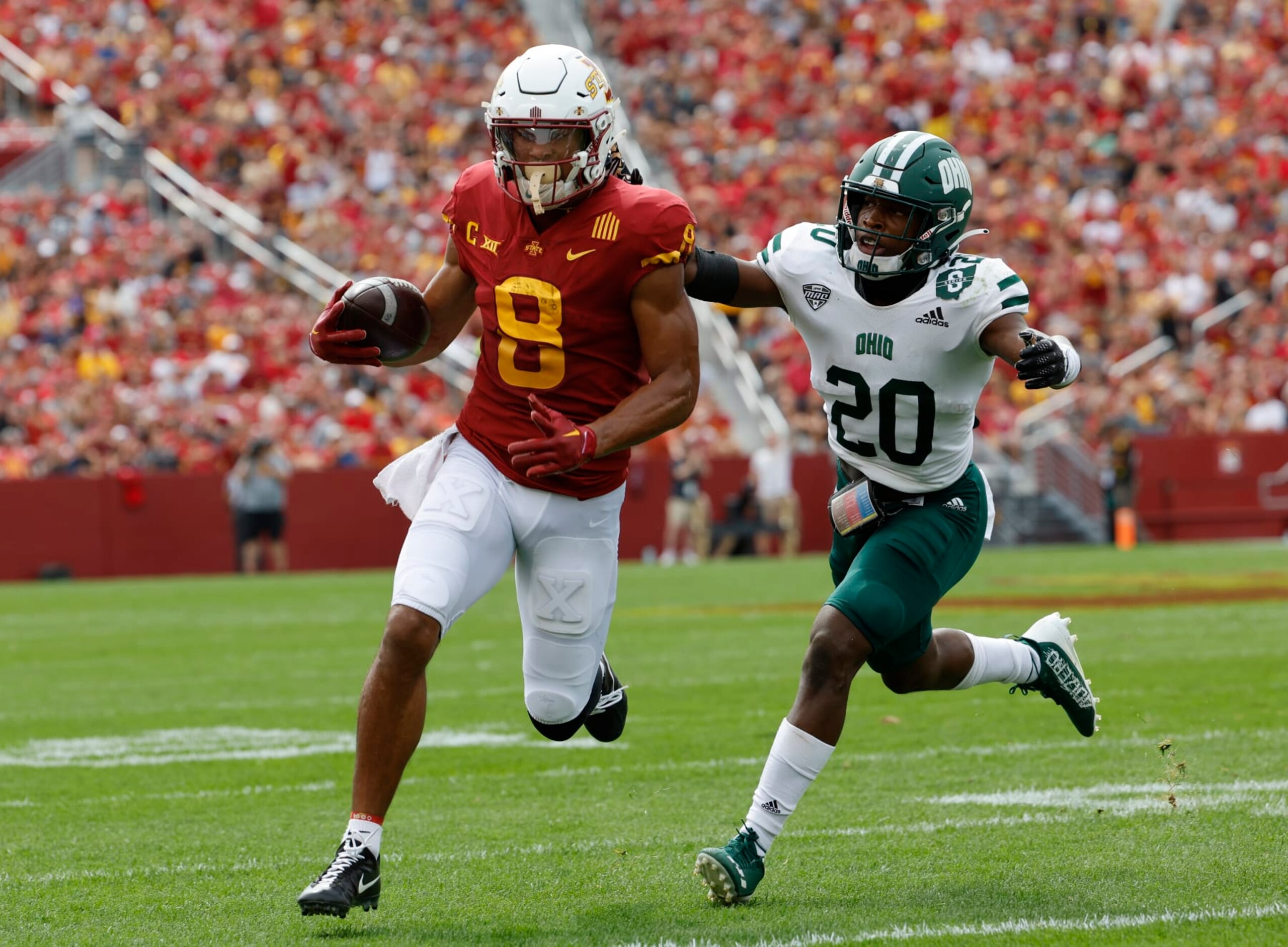 AMES, IA - SEPTEMBER 17:  Wide receiver Xavier Hutchinson #8 of the Iowa State Cyclones drives the ball past safety Alvin Floyd #20 of the Ohio Bobcats in the first half of play at Jack Trice Stadium on September 17, 2022 in Ames, Iowa. (Photo by David Purdy/Getty Images)