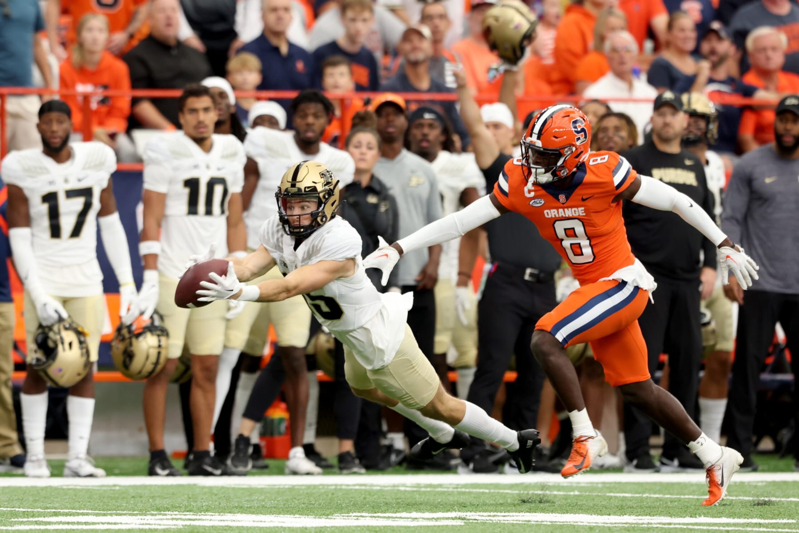 SYRACUSE, NEW YORK - SEPTEMBER 17: Charlie Jones #15 of the Purdue Boilermakers dives a catch as Garrett Williams #8 of the Syracuse Orange defends him during the first quarter at JMA Wireless Dome on September 17, 2022 in Syracuse, New York. (Photo by Bryan M. Bennett/Getty Images)