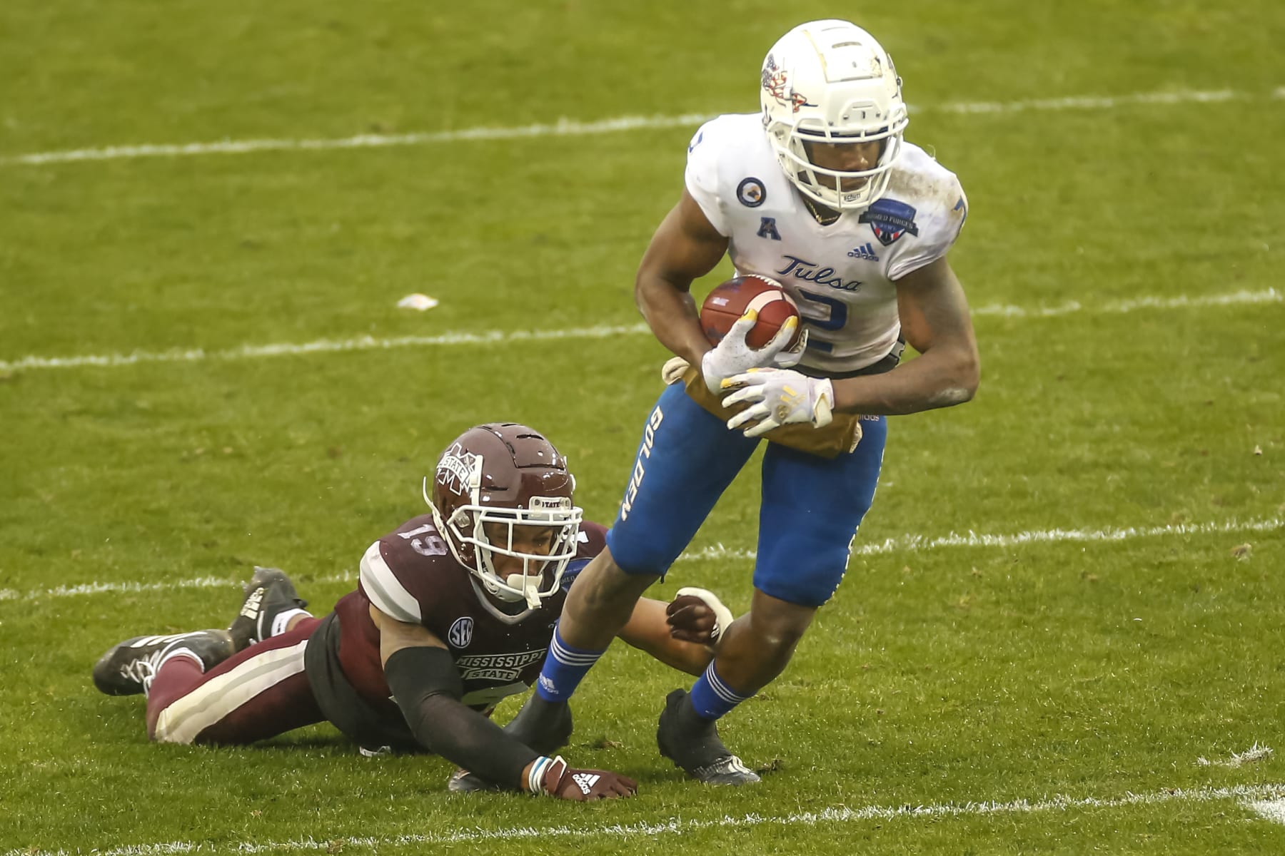 FORT WORTH, TX - DECEMBER 31: Tulsa Golden Hurricane wide receiver Keylon Stokes (2) gets tripped by Mississippi State Bulldogs safety Collin Duncan (19) during the Armed Forces Bowl game between the Tulsa Golden Hurricane and the Mississippi State Bulldogs on December 31, 2020 at Amon G. Carter Stadium in Fort Worth, Texas. (Photo by Matthew Pearce/Icon Sportswire via Getty Images)