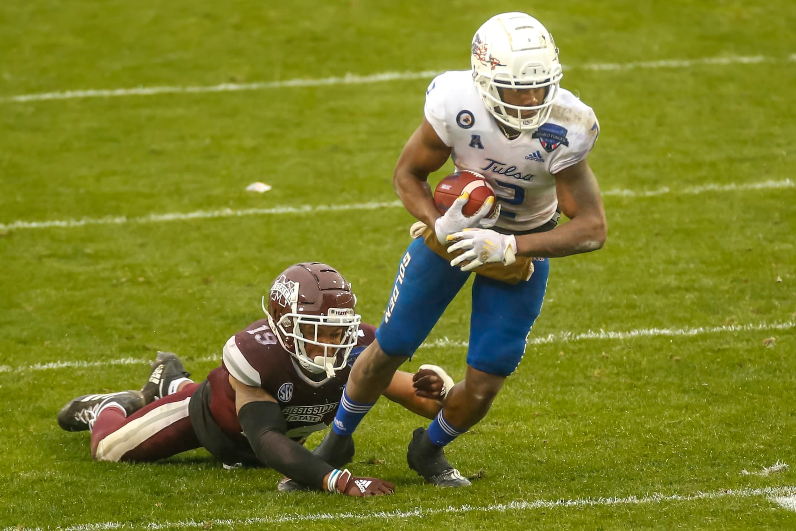 FORT WORTH, TX - DECEMBER 31: Tulsa Golden Hurricane wide receiver Keylon Stokes (2) gets tripped by Mississippi State Bulldogs safety Collin Duncan (19) during the Armed Forces Bowl game between the Tulsa Golden Hurricane and the Mississippi State Bulldogs on December 31, 2020 at Amon G. Carter Stadium in Fort Worth, Texas. (Photo by Matthew Pearce/Icon Sportswire via Getty Images)