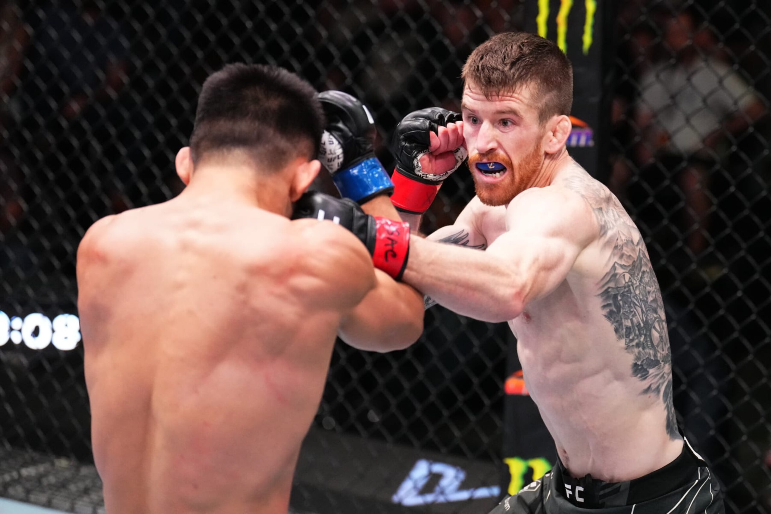 LAS VEGAS, NEVADA - SEPTEMBER 17: (R-L) Cory Sandhagen punches Song Yadong of China in a bantamweight fight during the UFC Fight Night event at UFC APEX on September 17, 2022 in Las Vegas, Nevada. (Photo by Chris Unger/Zuffa LLC)