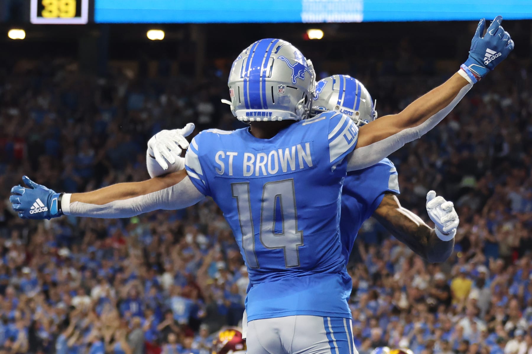 DETROIT, MICHIGAN - SEPTEMBER 18: Amon-Ra St. Brown #14 of the Detroit Lions is congratulated after a making a catch for a touchdown against the Washington Commanders during the first quarter at Ford Field on September 18, 2022 in Detroit, Michigan. (Photo by Gregory Shamus/Getty Images)