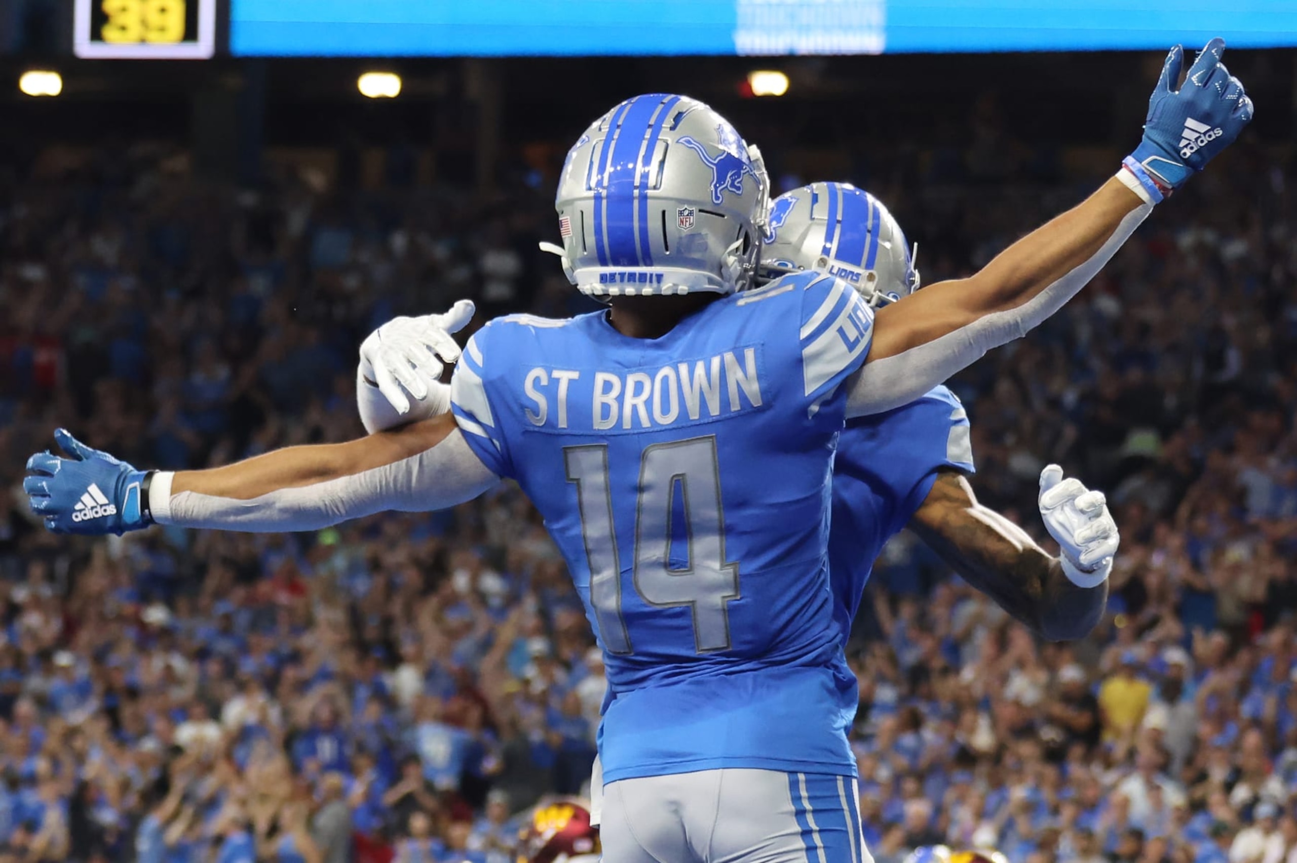 DETROIT, MICHIGAN - SEPTEMBER 18: Amon-Ra St. Brown #14 of the Detroit Lions is congratulated after a making a catch for a touchdown against the Washington Commanders during the first quarter at Ford Field on September 18, 2022 in Detroit, Michigan. (Photo by Gregory Shamus/Getty Images) DETROIT, MICHIGAN - SEPTEMBER 18: Amon-Ra St. Brown #14 of the Detroit Lions is congratulated after a making a catch for a touchdown against the Washington Commanders during the first quarter at Ford Field on September 18, 2022 in Detroit, Michigan. (Photo by Gregory Shamus/Getty Images)
