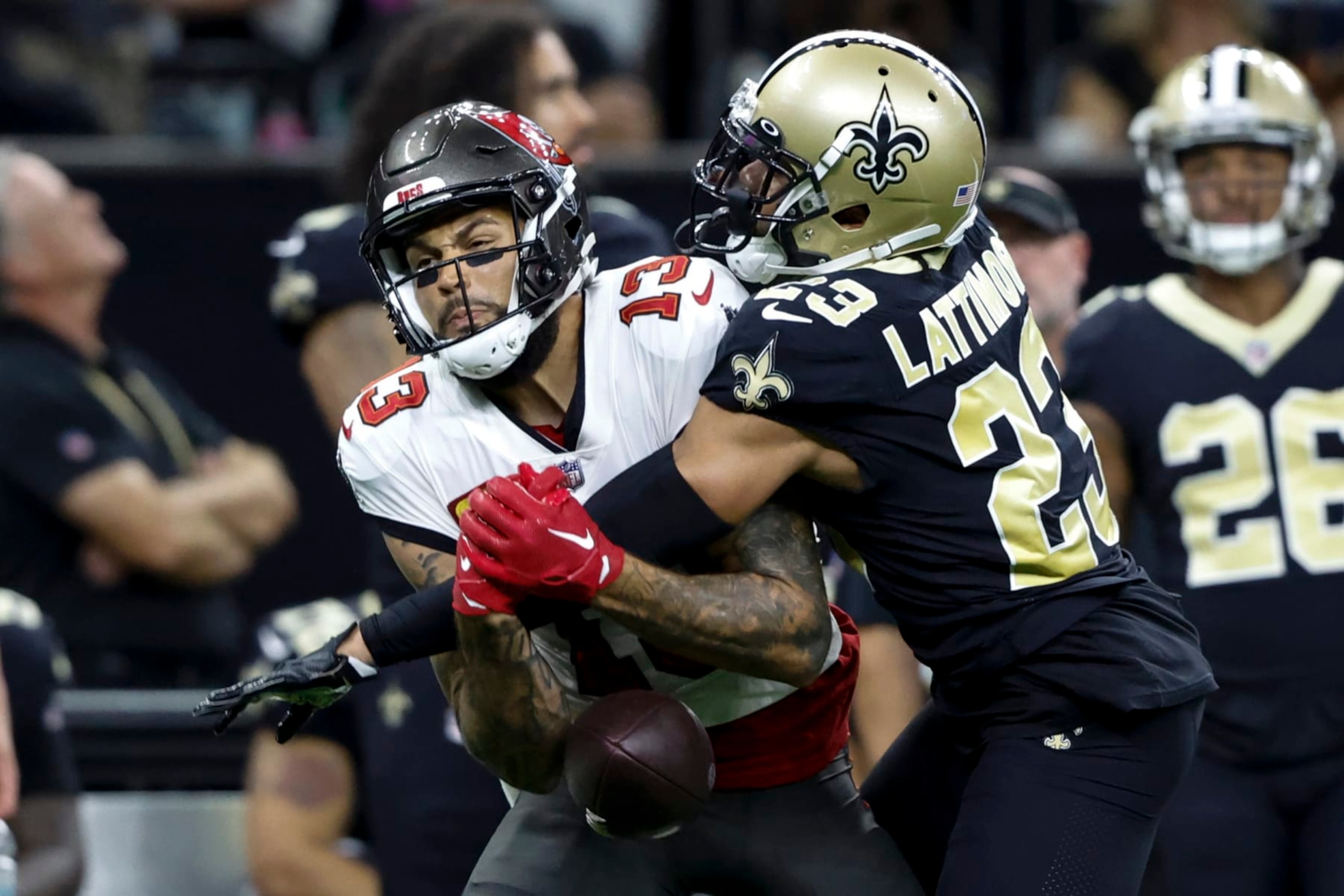 New Orleans Saints cornerback Marshon Lattimore breaks up a pass intended for Tampa Bay Buccaneers wide receiver Mike Evans during the first half of an NFL football game in New Orleans, Sunday, Sept. 18, 2022. (AP Photo/Butch Dill)