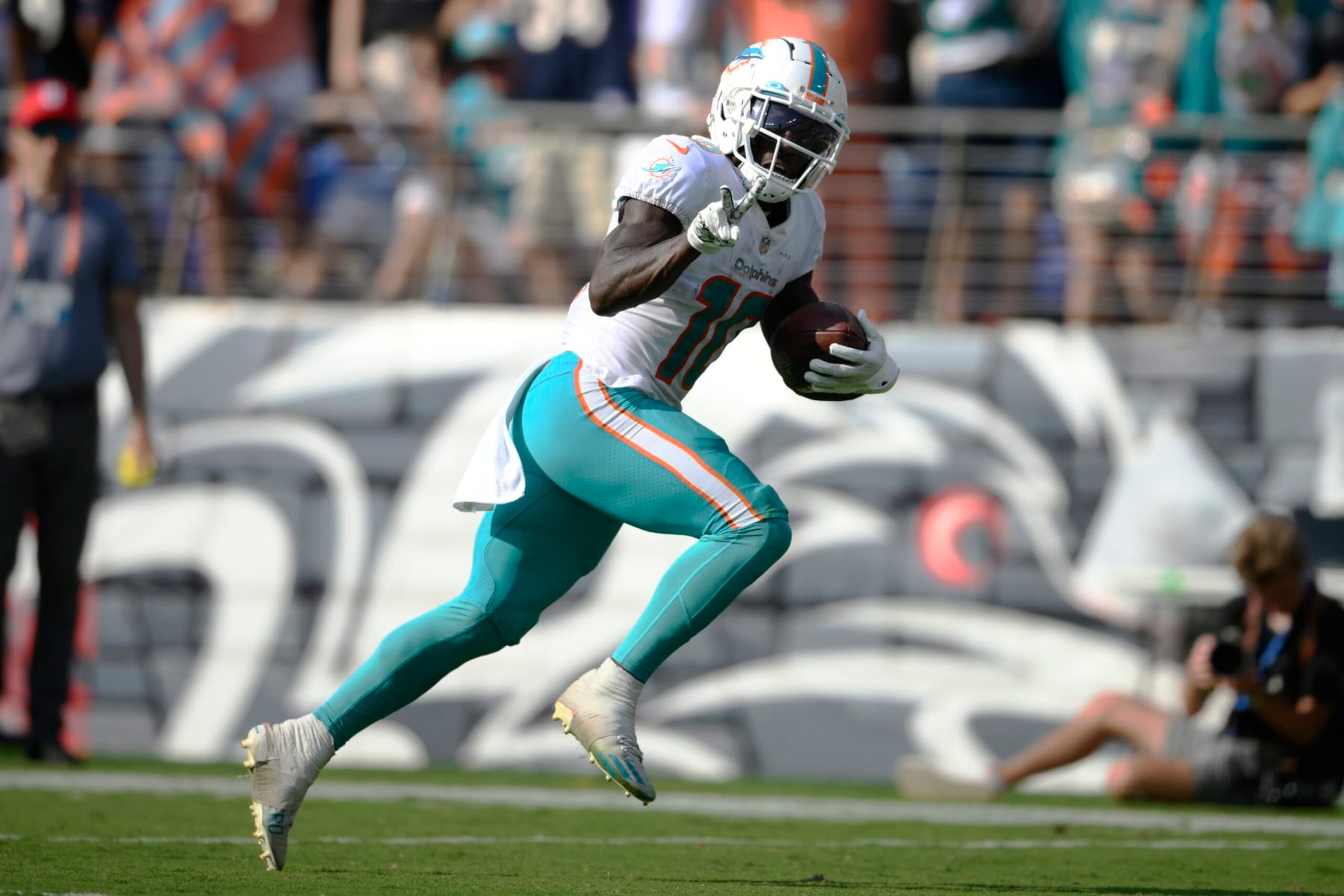 Miami Dolphins wide receiver Tyreek Hill (10) gestures as he runs for a touchdown during the second half of an NFL football game against the Baltimore Ravens, Sunday, Sept. 18, 2022, in Baltimore. (AP Photo/Nick Wass)