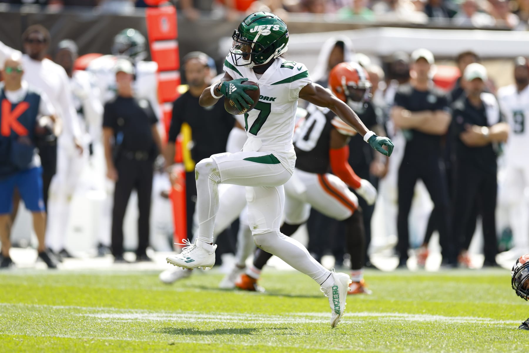 New York Jets wide receiver Garrett Wilson (17) takes off after he escapes the grasp of New York Jets running back Breece Hall (20) after making a catch during the first half of an NFL football game, Sunday, Sept. 18, 2022, in Cleveland. (AP Photo/Ron Schwane)